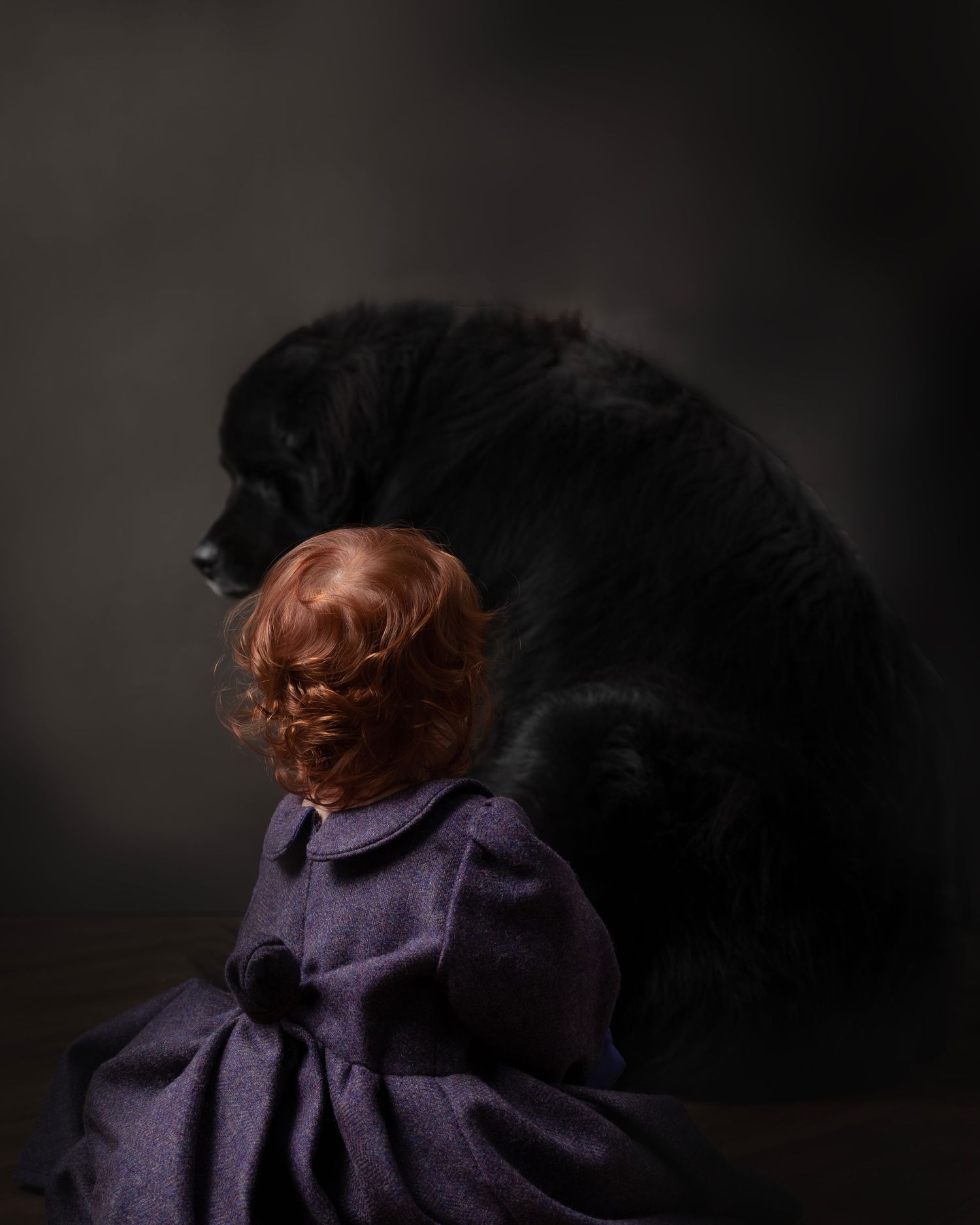 A figure in a purple dress moves dynamically against a dark background creating a dramatic silhouetted effect.