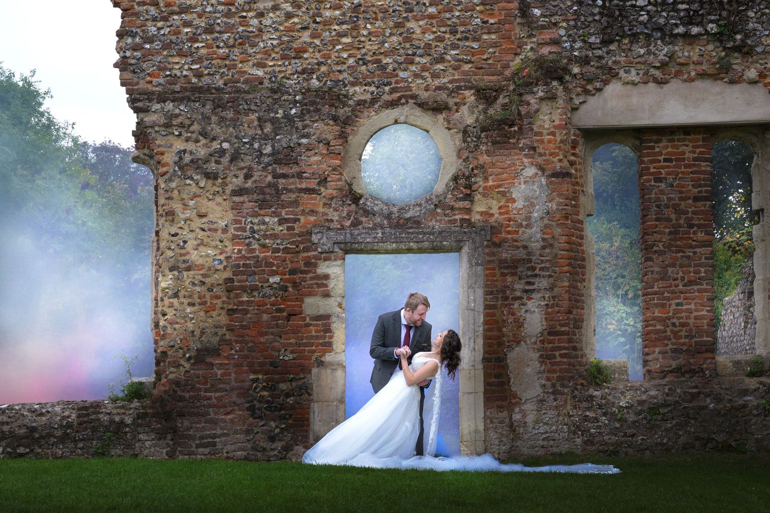 Couple shares romantic moments in a rustic stone courtyard during their wedding photoshoot.
