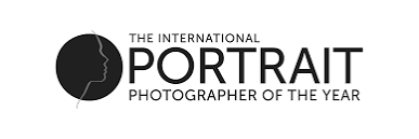 Portrait Photographer of the Year award logo in black and white circular design.
