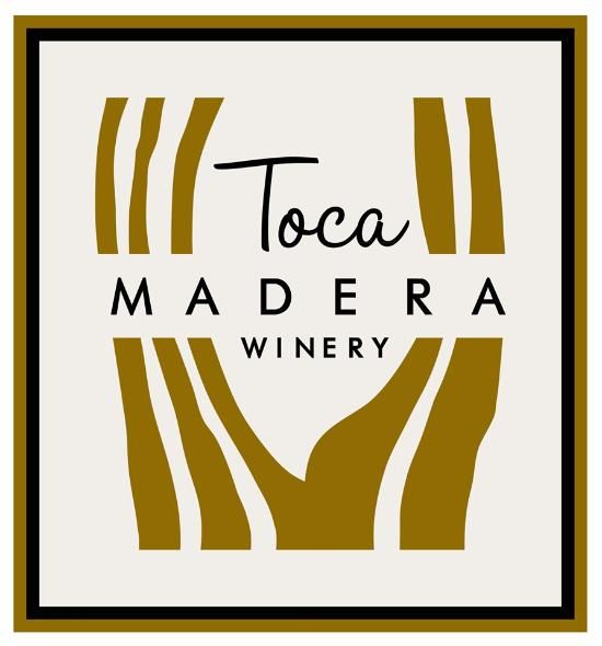 Minimalist gold and black wine label design for Toca Madera Winery featuring abstract flowing lines.