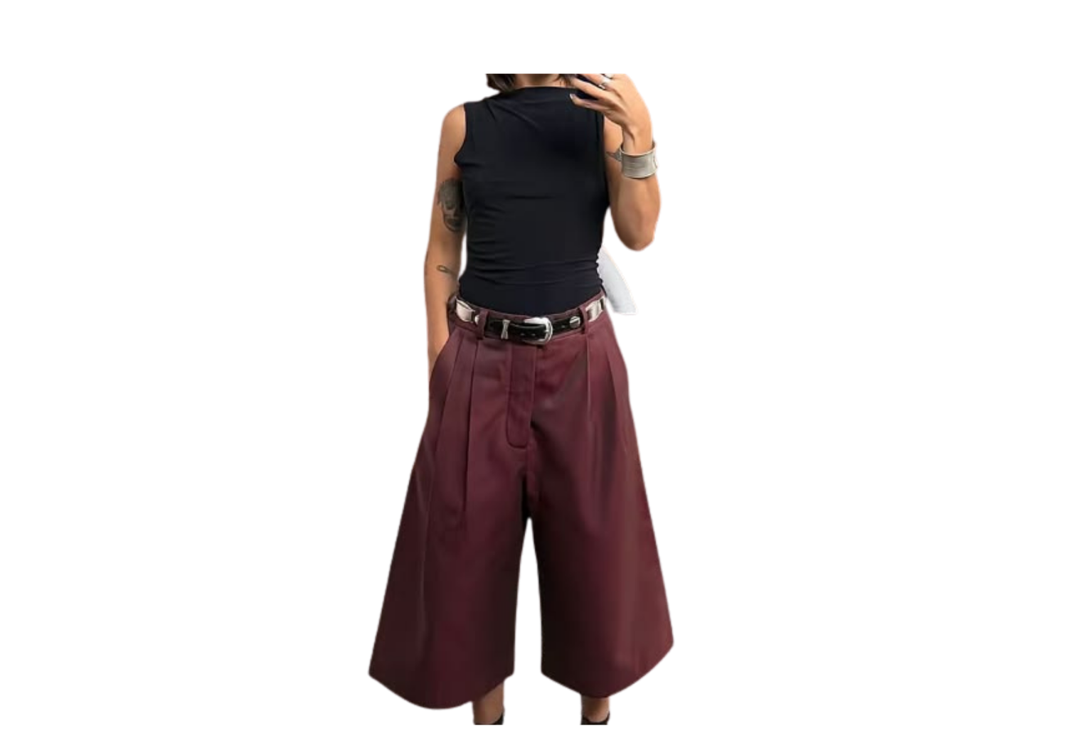 Person wearing black sleeveless top with burgundy wide-leg culottes and black belt, fashion outfit photo.