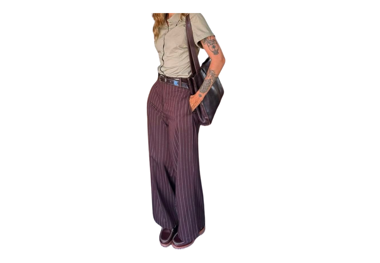Woman wearing wide-leg dark striped trousers with a light shirt, belt, and carrying a shoulder bag.