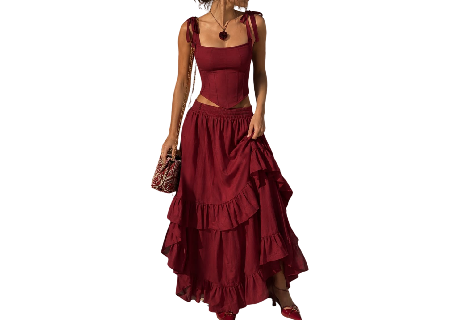 Woman wearing a burgundy red two-piece maxi dress set with ruffle skirt and square neck crop top.