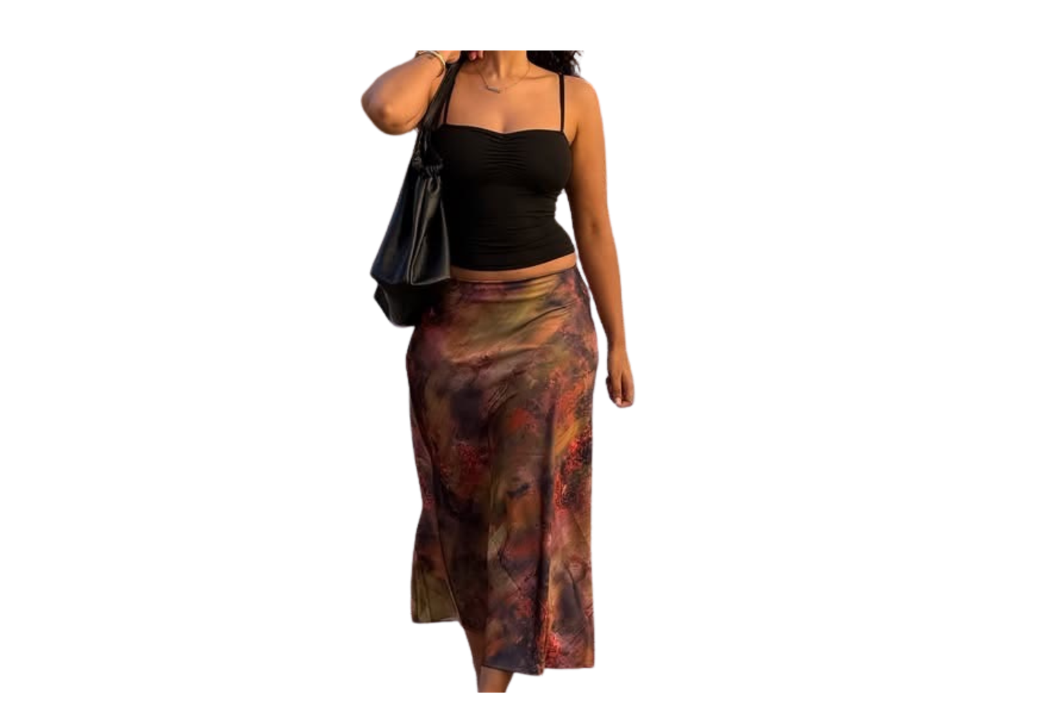 Woman wearing black crop top with colorful tie-dye midi skirt and black shoulder bag.