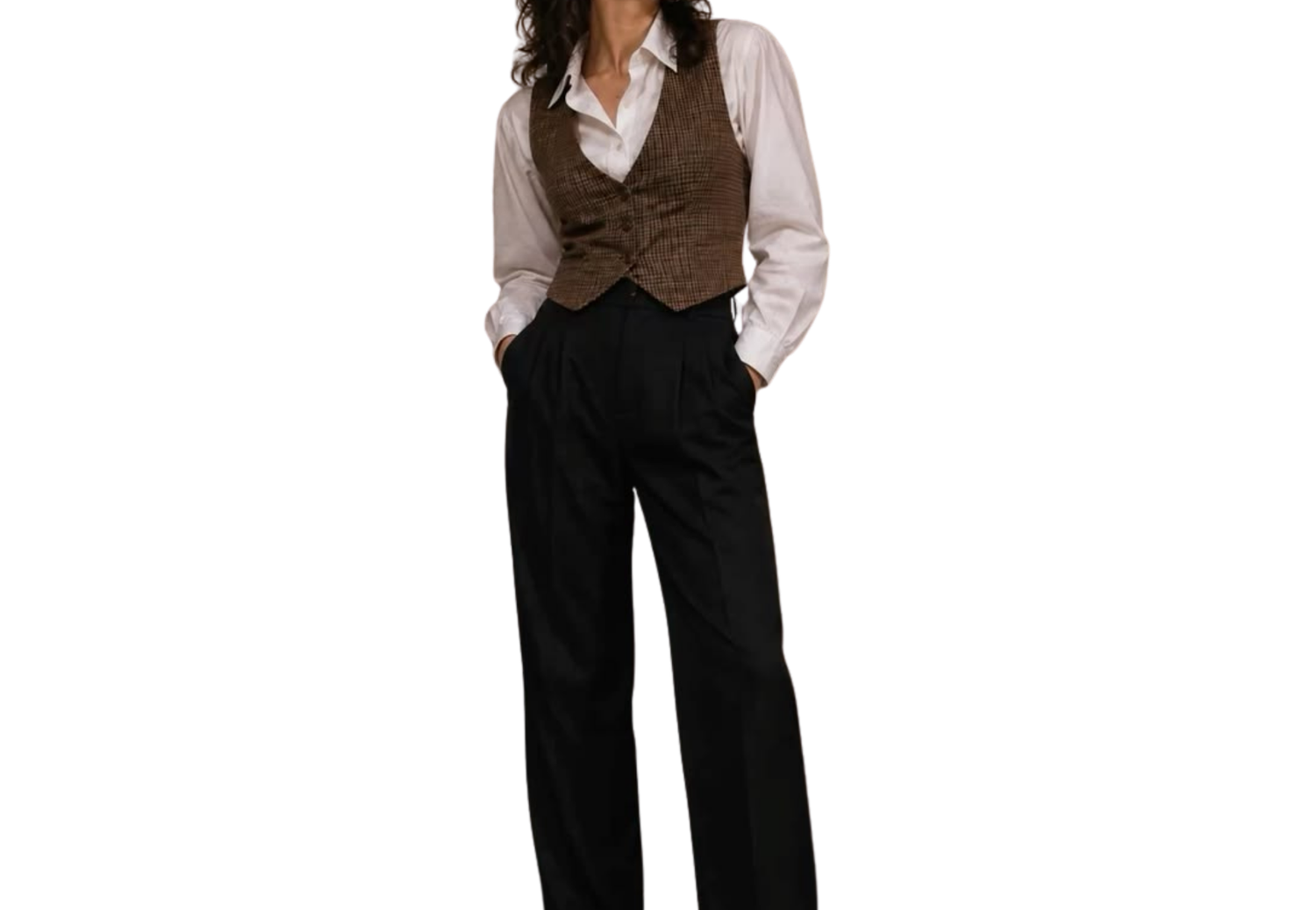 Woman wearing a brown vest over a white shirt with black wide-leg trousers, hands in pockets.