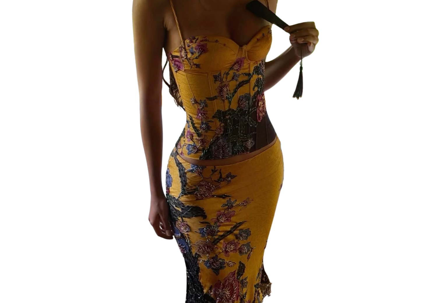 Woman wearing a yellow floral print spaghetti strap midi dress with lace hem detailing.