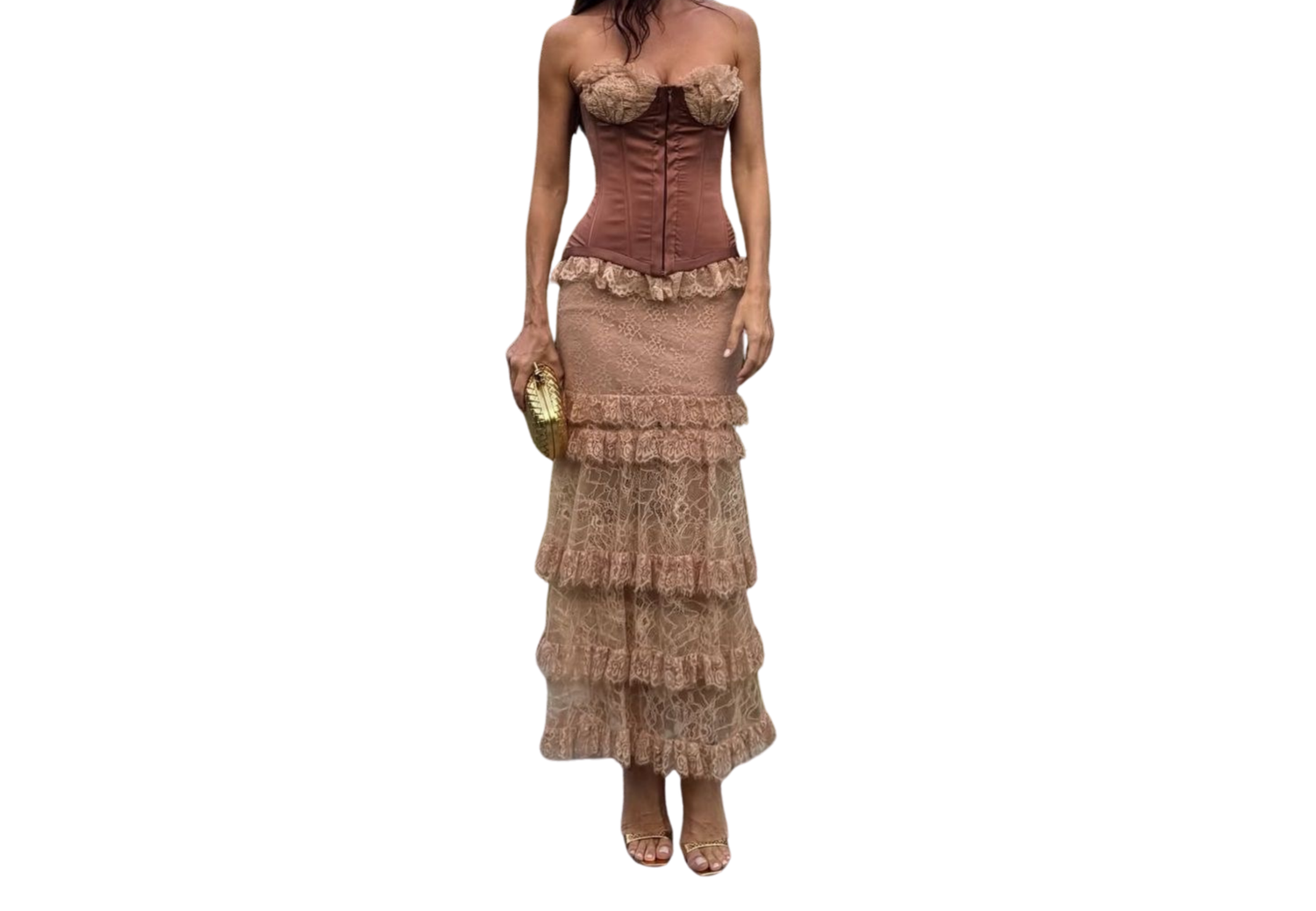 Woman wearing a brown corset top with tiered lace maxi skirt and heels, holding a gold clutch.