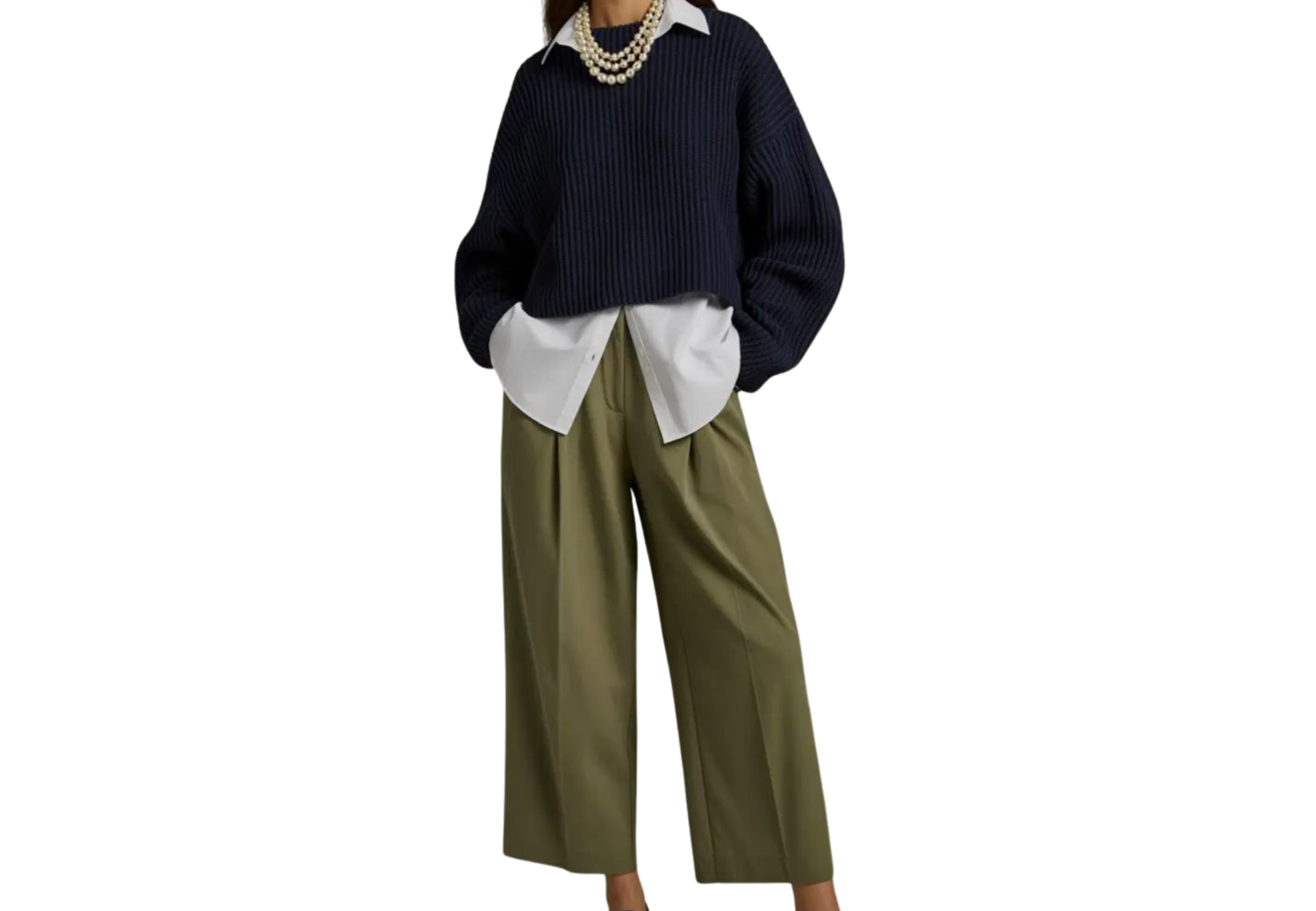 Model wearing navy oversized sweater layered over white shirt with olive wide-leg trousers and pearl necklace.
