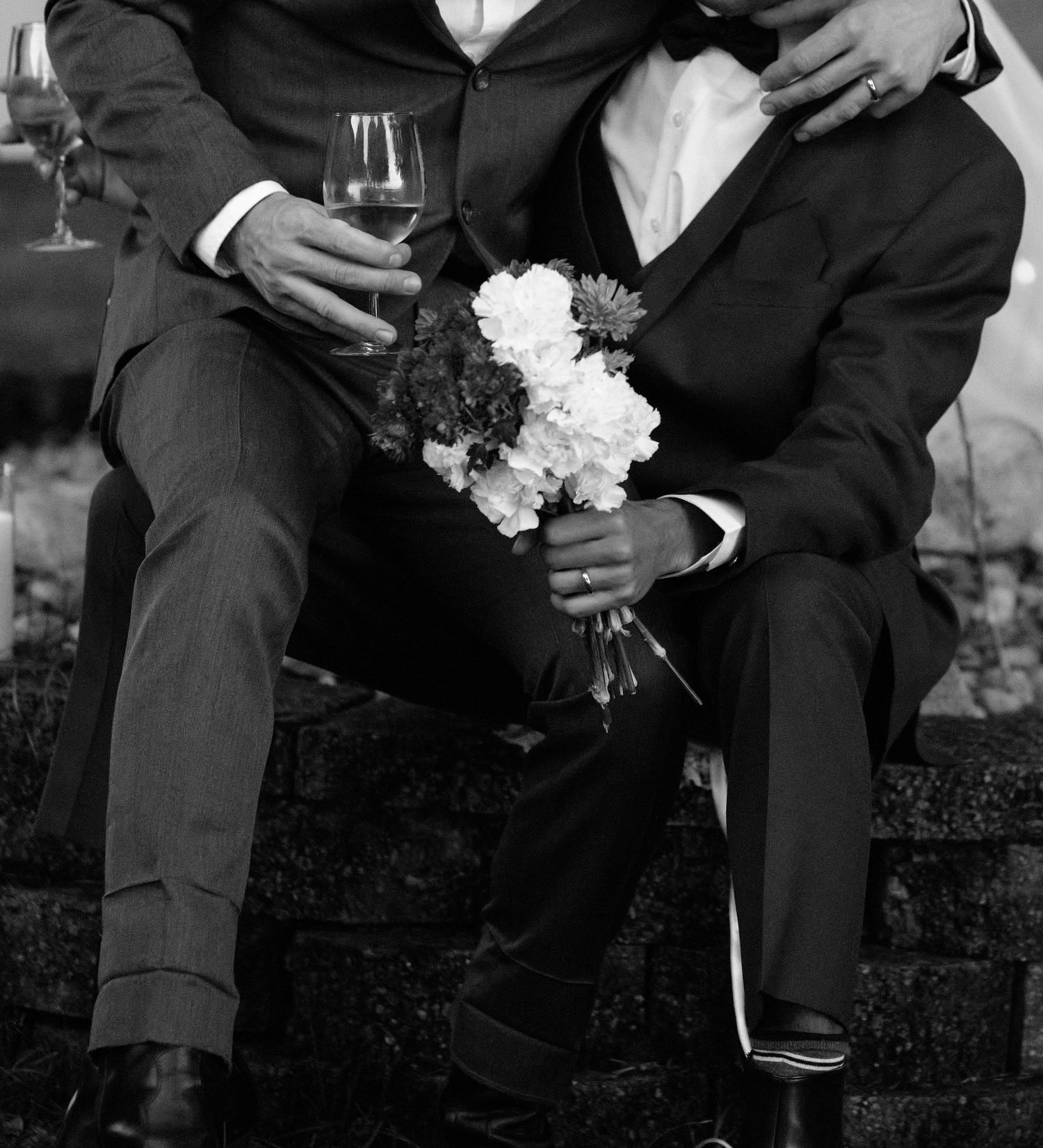 Black and white wedding photos showing formal attire and floral bouquets in an outdoor garden setting.
