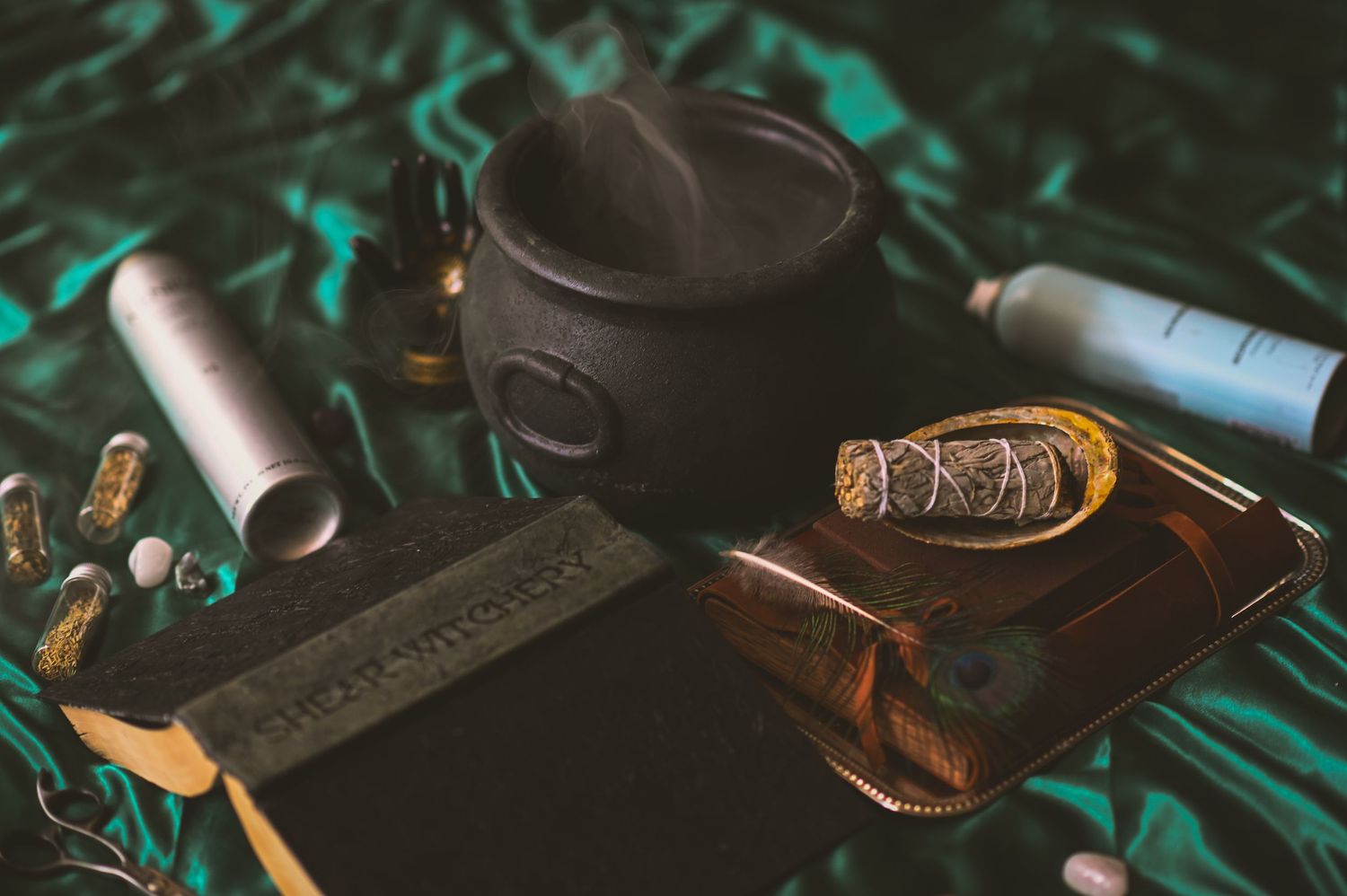 Vintage camera equipment and accessories arranged artistically on a dark surface with turquoise lighting.