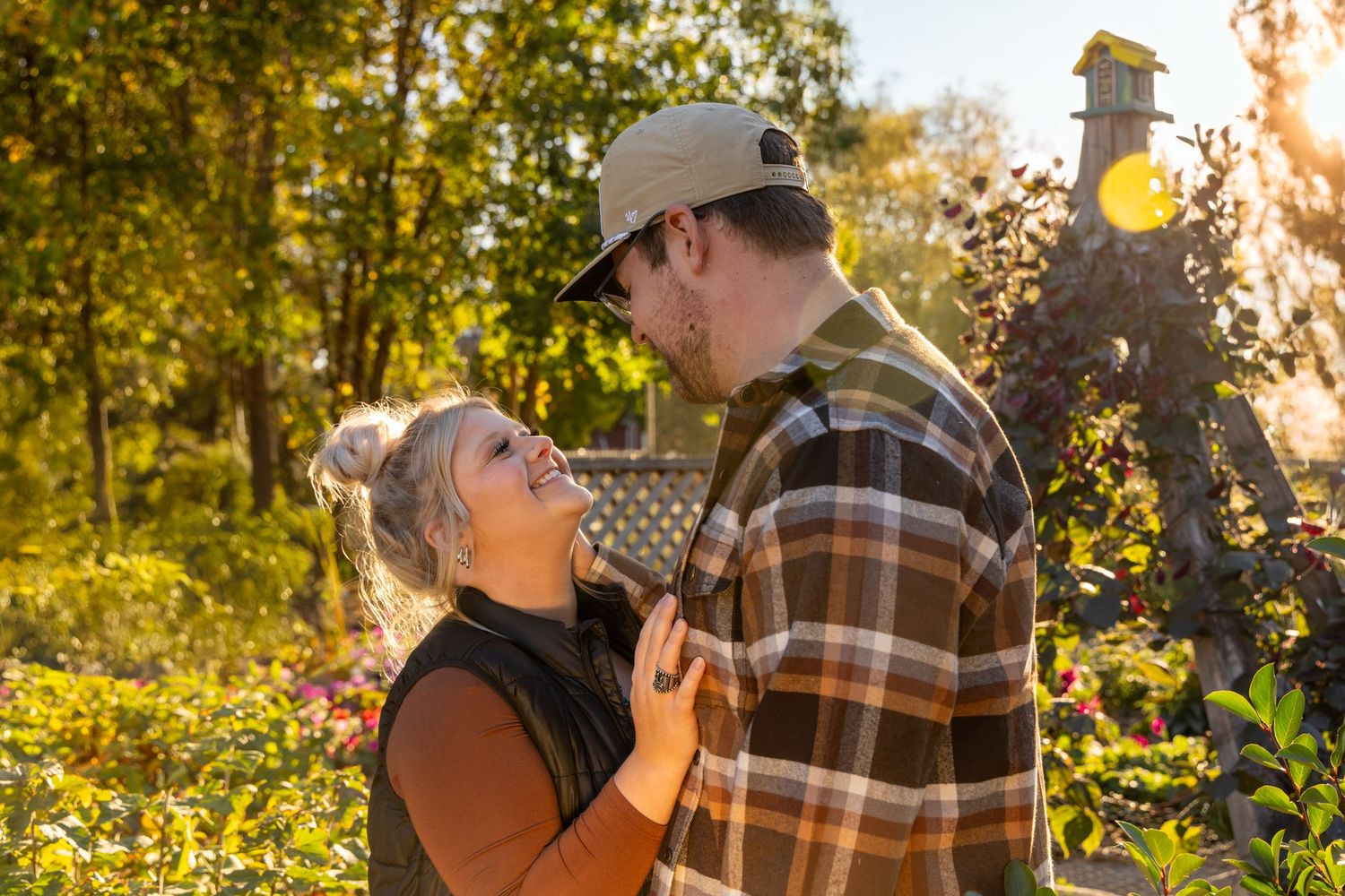 Golden hour couple photography with warm sunlight filtering through autumn trees.