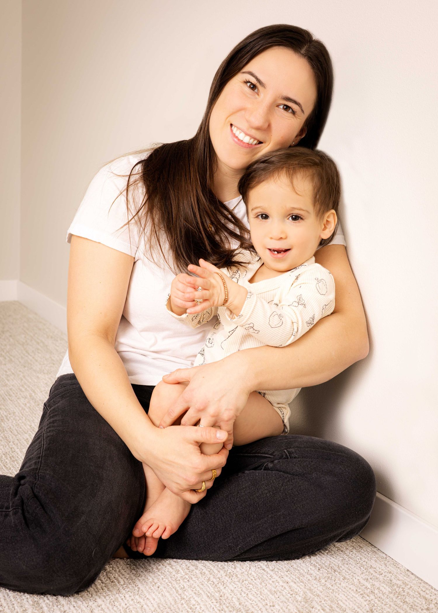 A gentle portrait of parent and child sitting together and sharing a sweet moment.