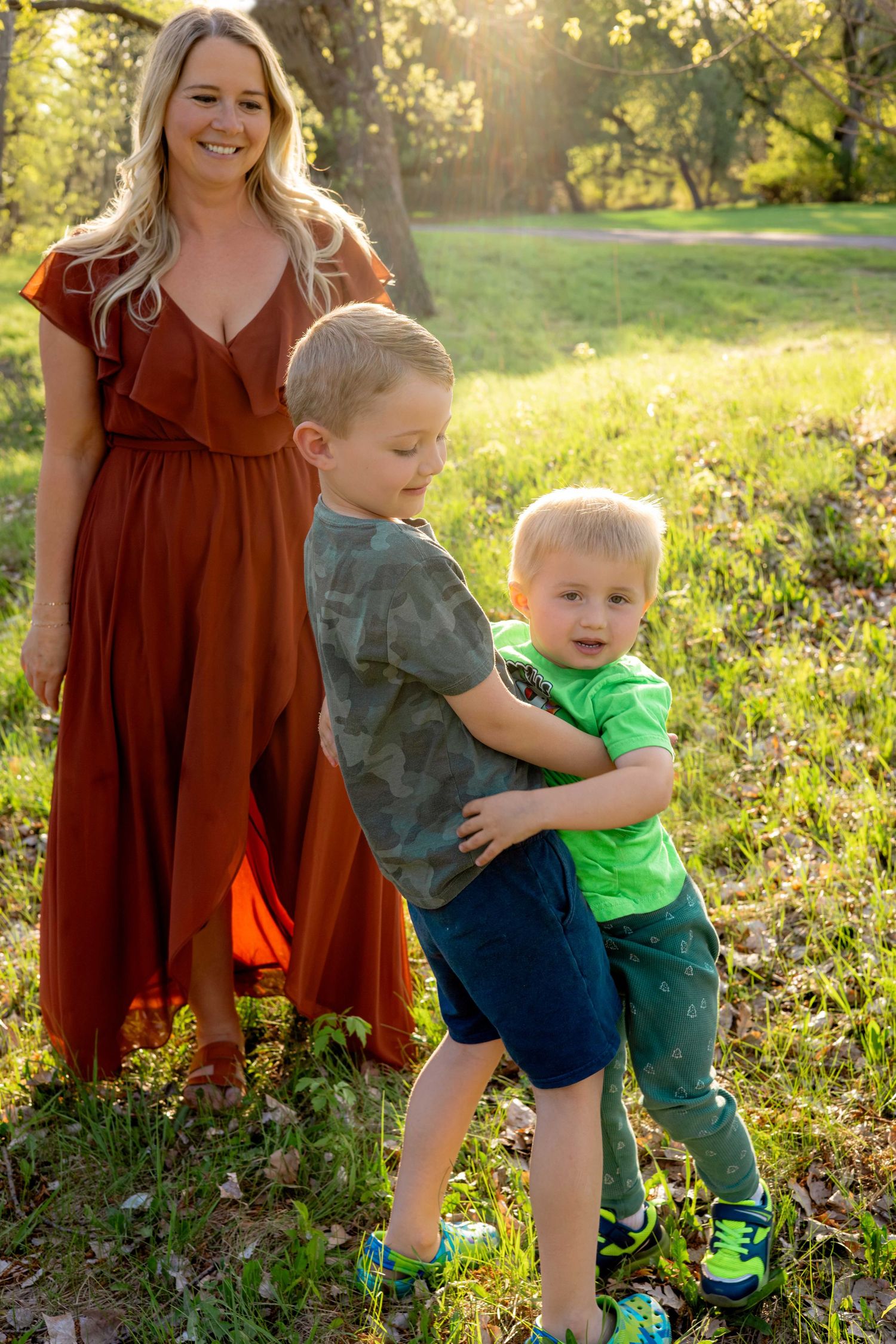 Candid moments of play and laughter in a spring meadow during sunset.