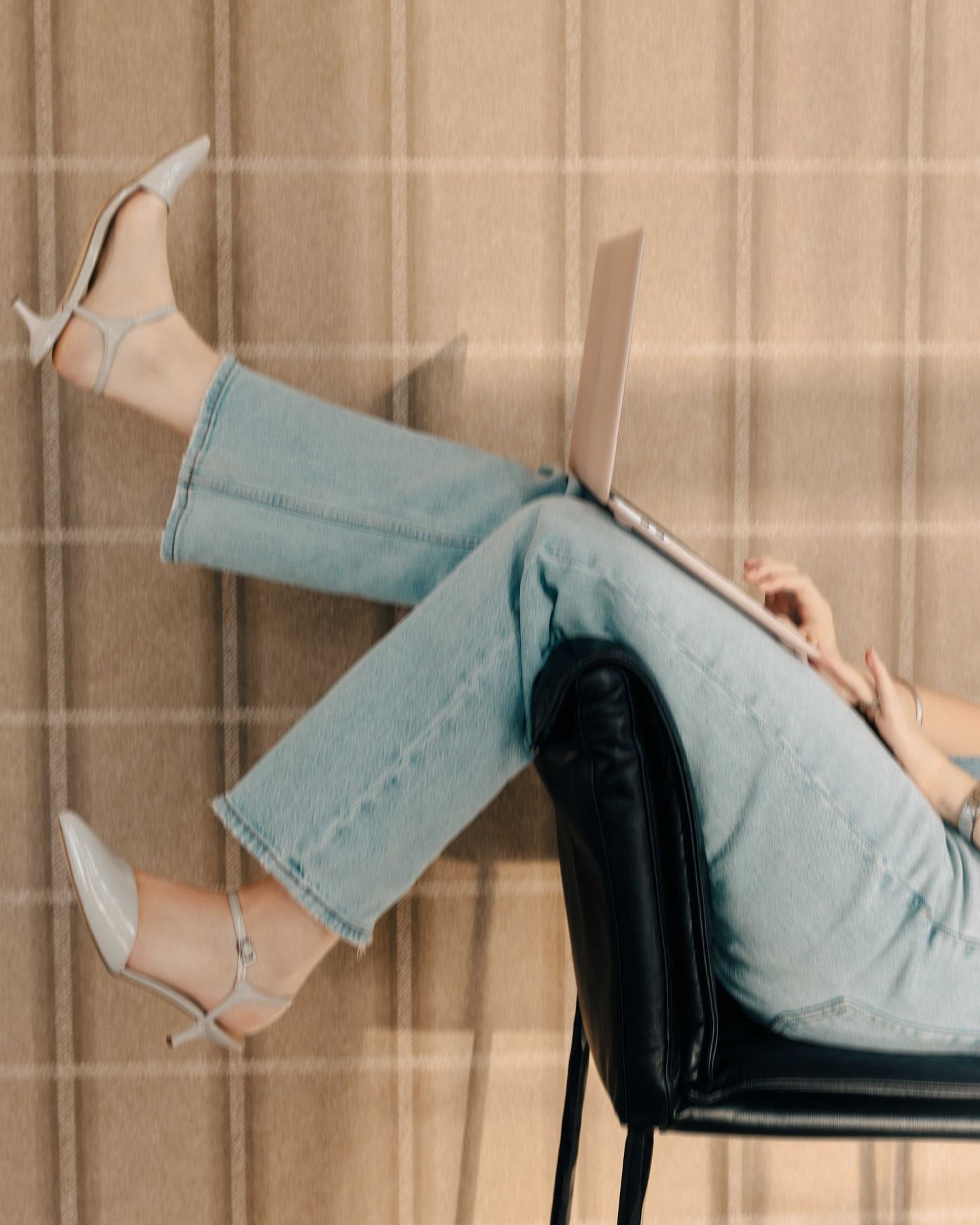 Light blue high heels displayed on reflective surface with dramatic lighting.