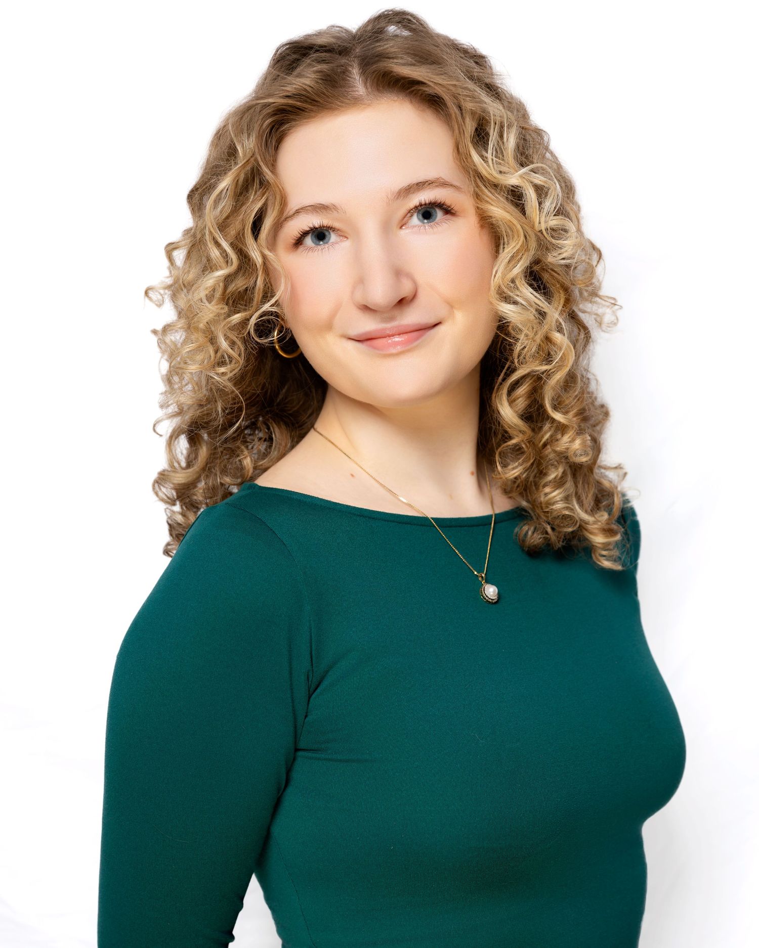 Professional headshot series of a person with curly blonde hair wearing a dark green top against a white background.