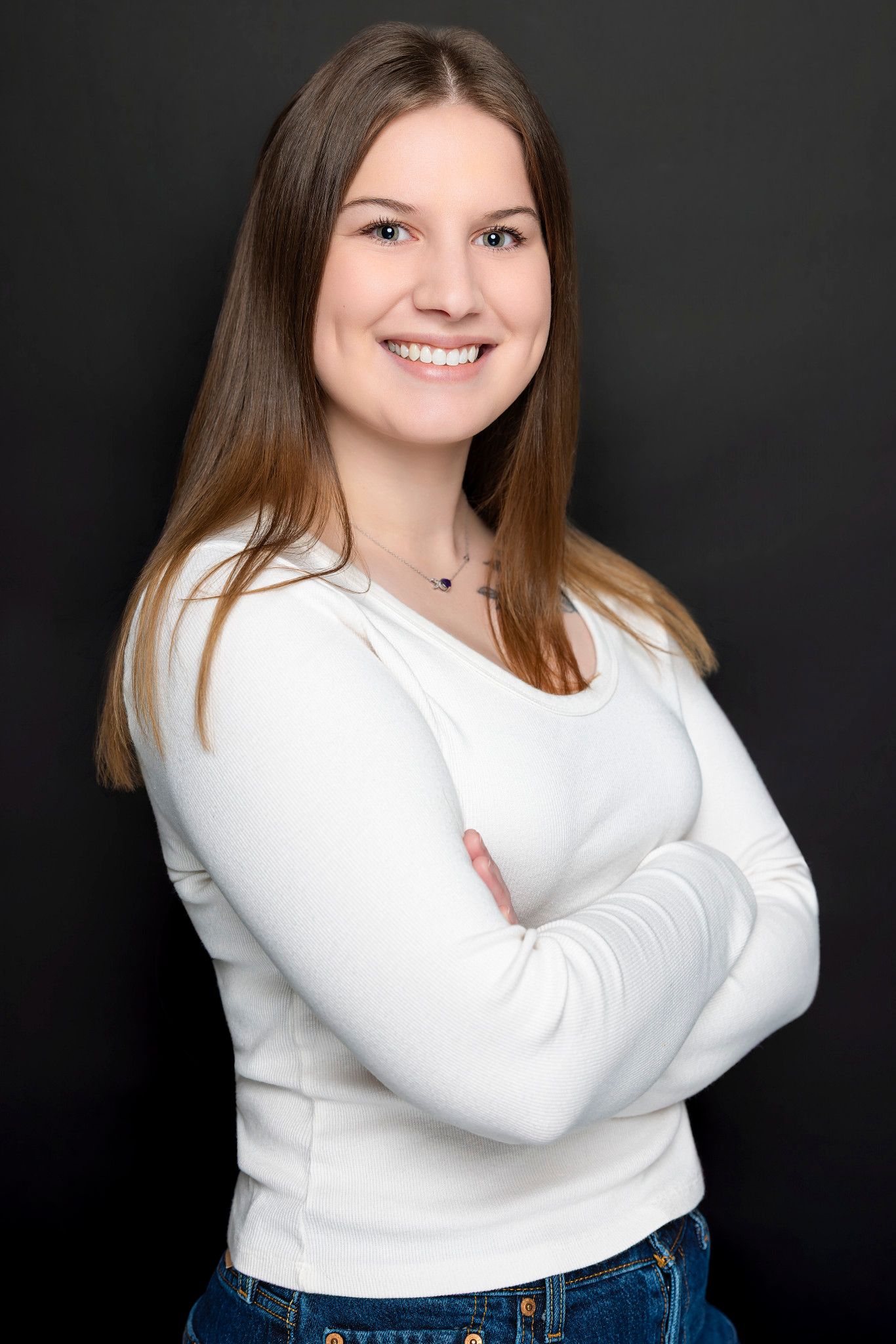Portrait series in white long sleeve top against dark background showing different poses.
