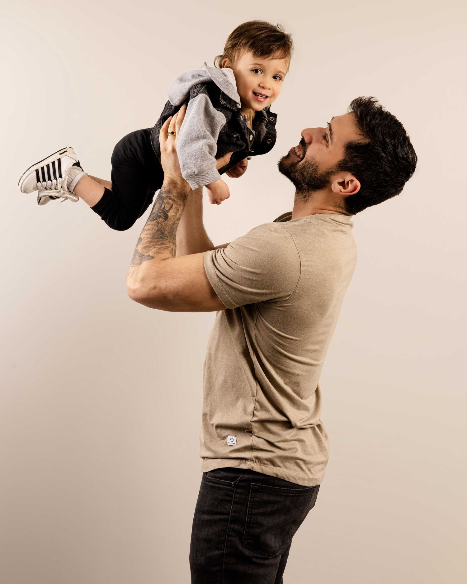 Playful studio sequence showing joyful lifting moments against white background.