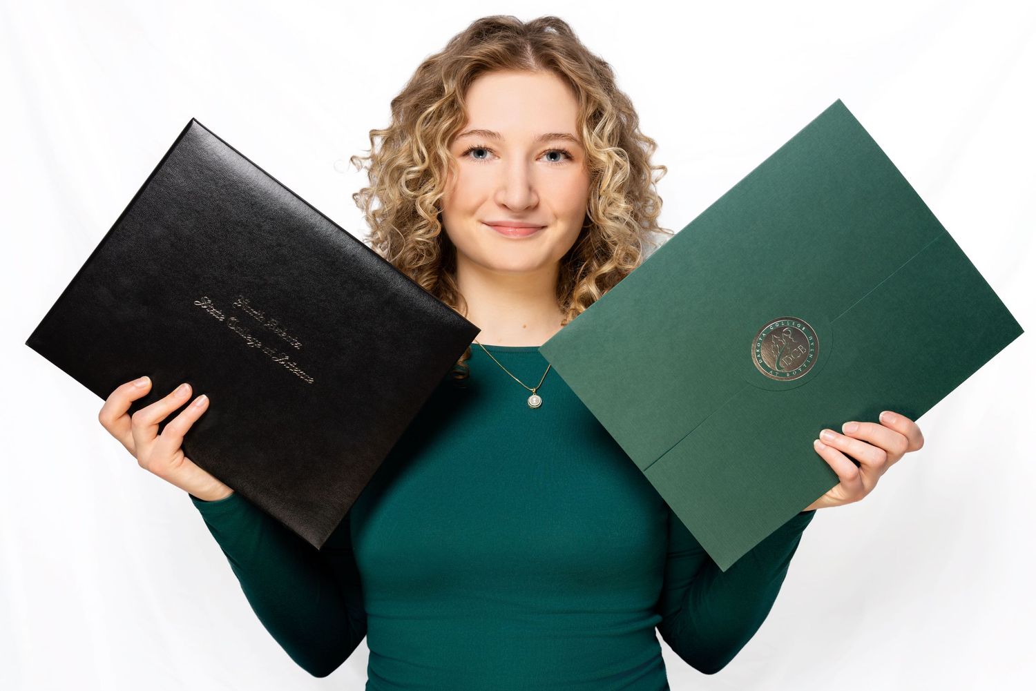 Sequence of images showing someone holding and opening a dark green diploma folder against a white background.