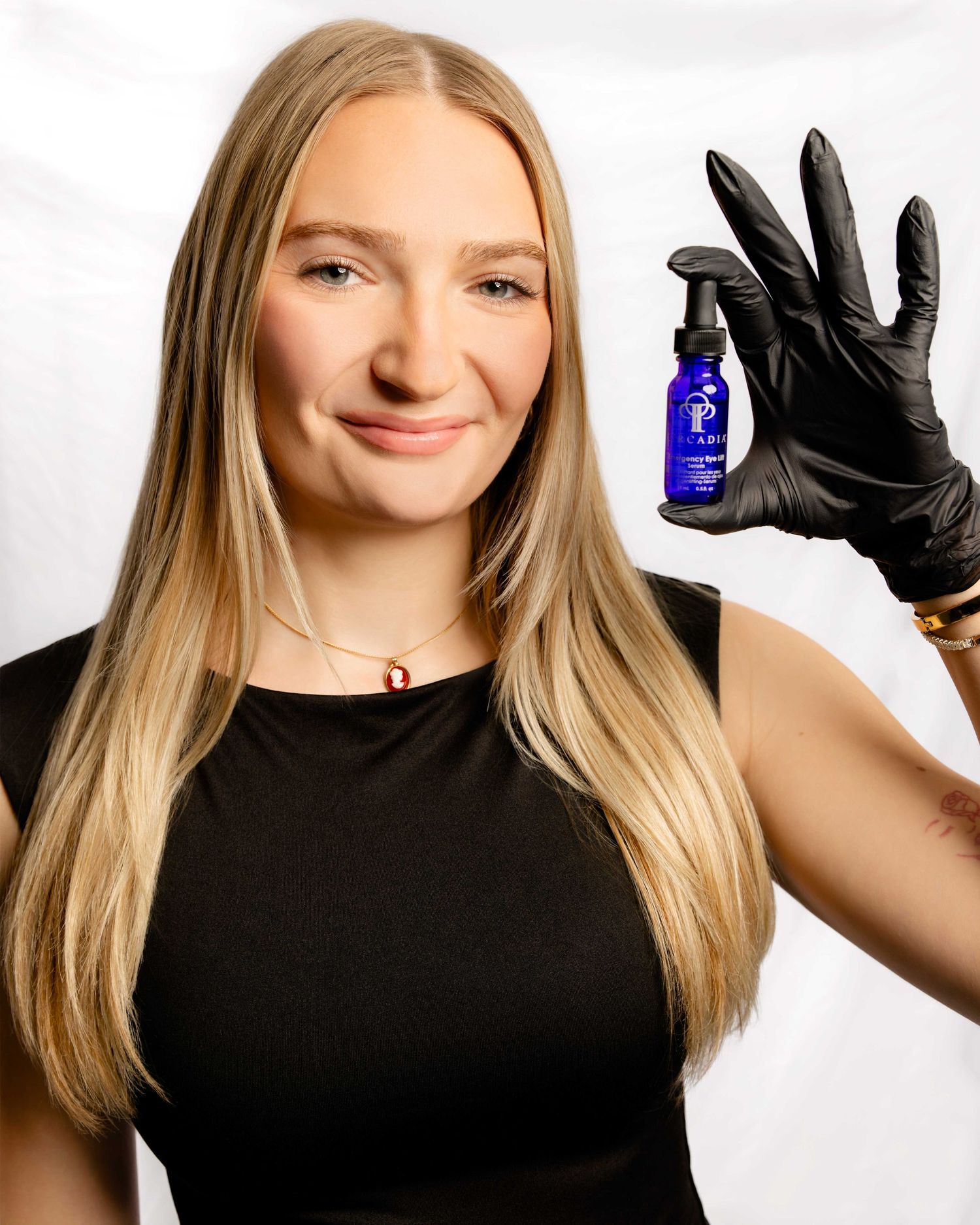 Series showing hands in black gloves holding blue bottle against white background.
