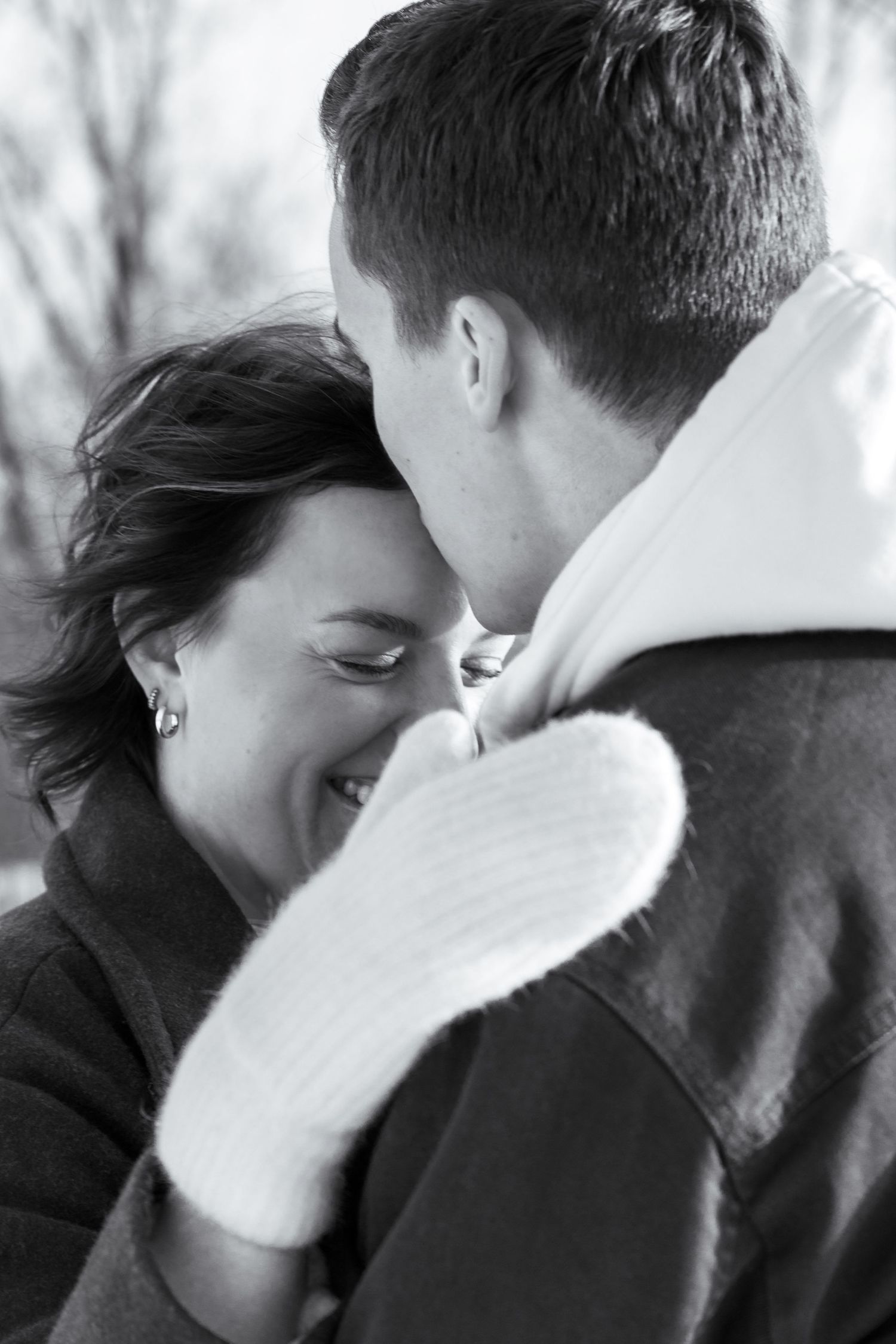 Black and white intimate portrait of couple sharing tender moment.