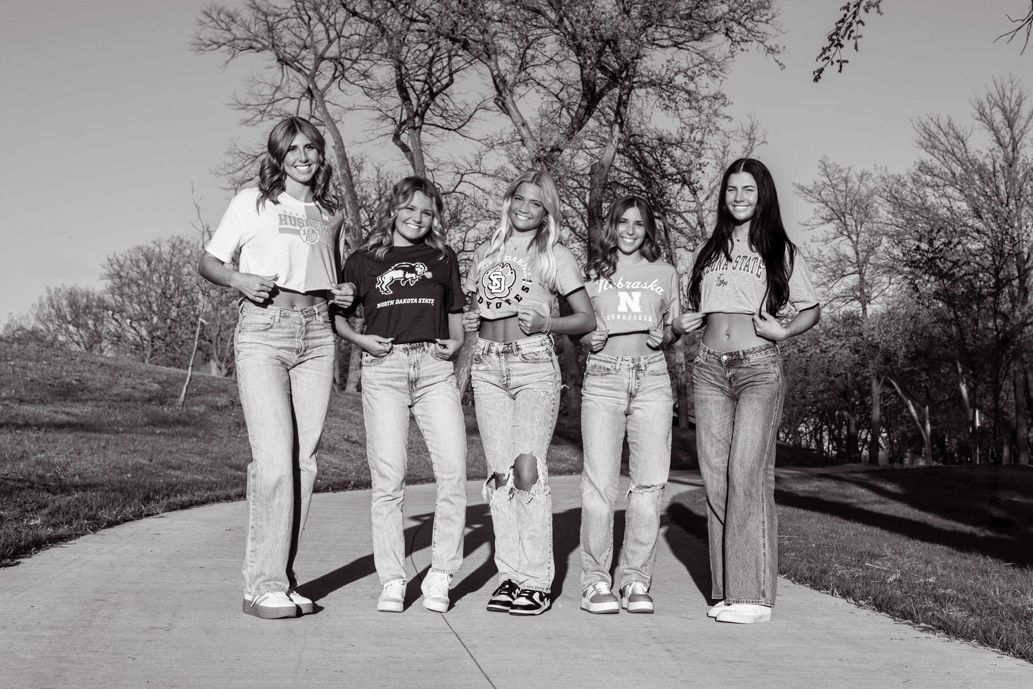 Black and white panoramic series showing legs and feet of people lined up outdoors.
