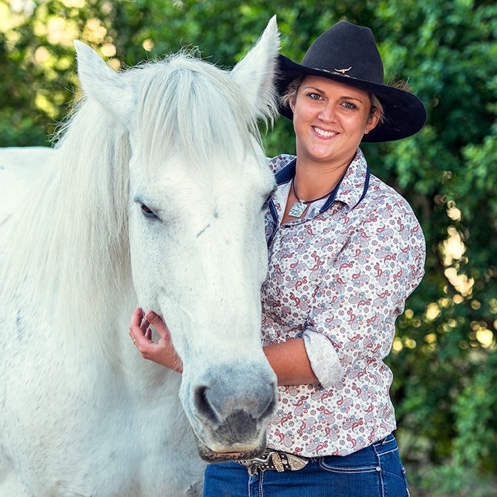 Sequence of shots showing a white horse with handler in western attire outdoors.
