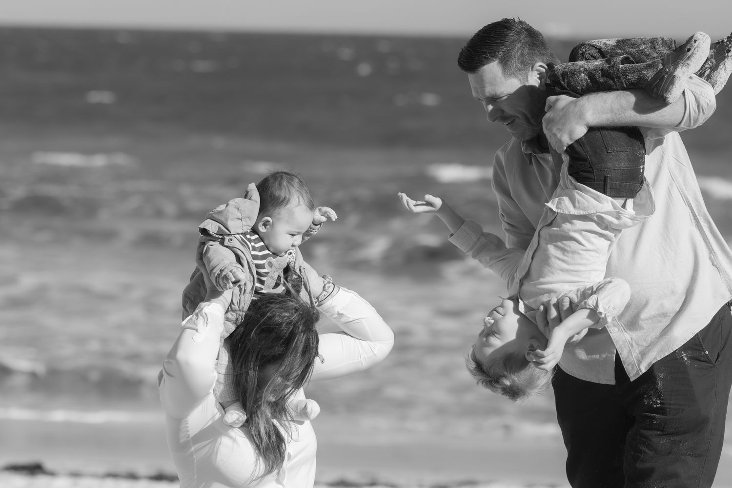 Playful beach wedding photos with couple dancing and spinning in black and white. Perth family photography Fremantle