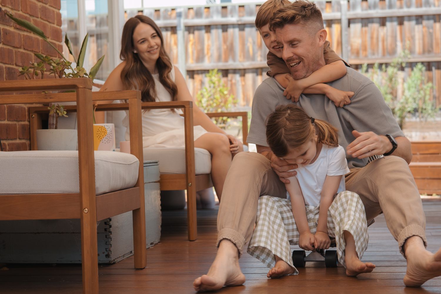 A family shares a joyful moment together while relaxing on their outdoor patio furniture.