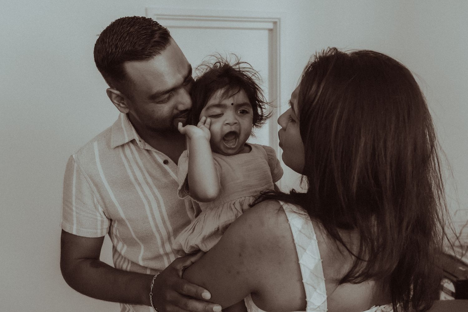 A black and white photo series showing tender moments between a couple in romantic poses and embraces.