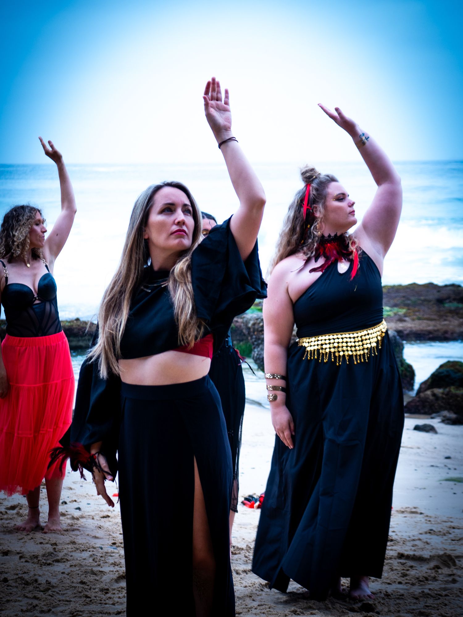 Group of women dancing/ performing on beach