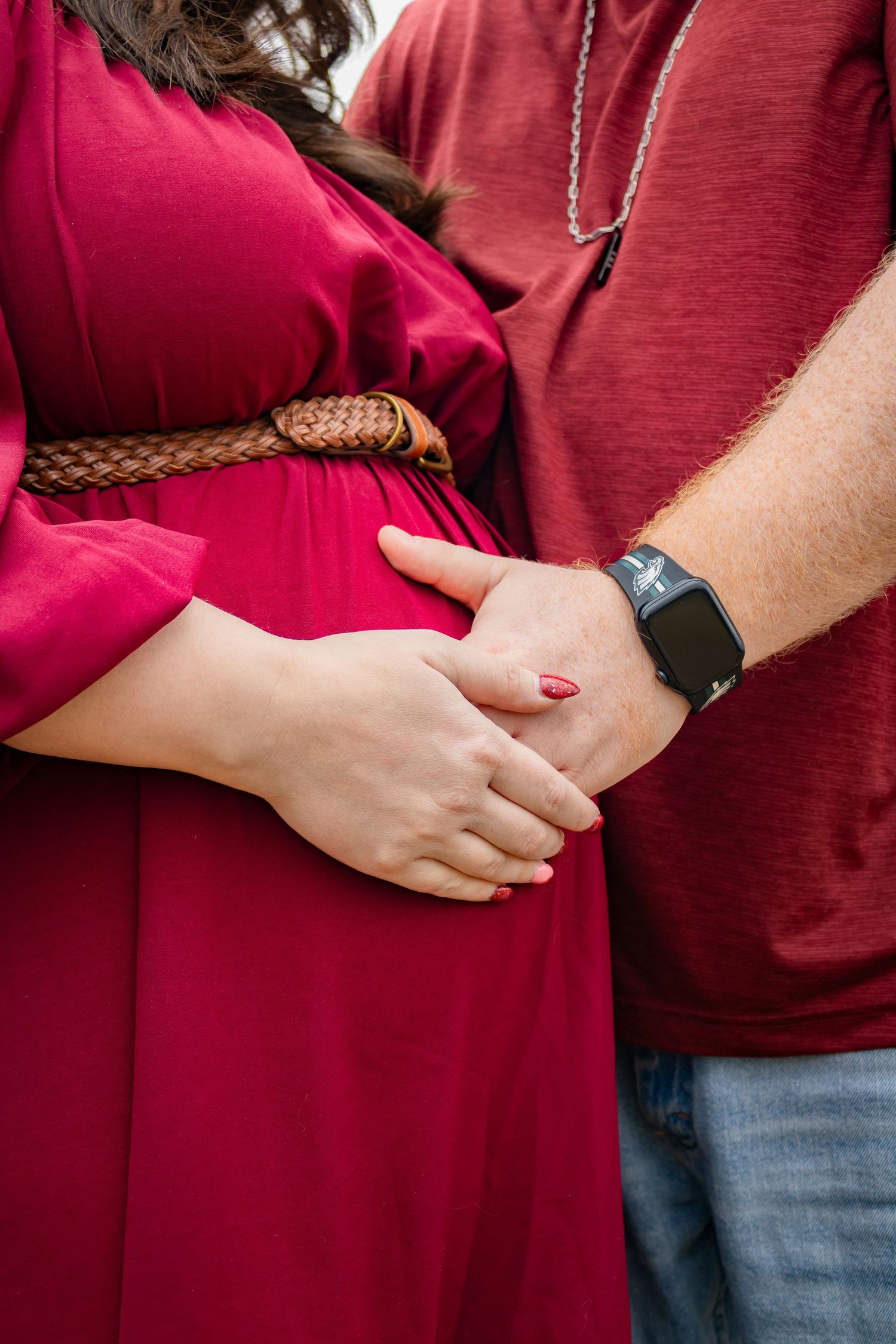 Sequence showing a pregnant woman's growing belly in a red dress.