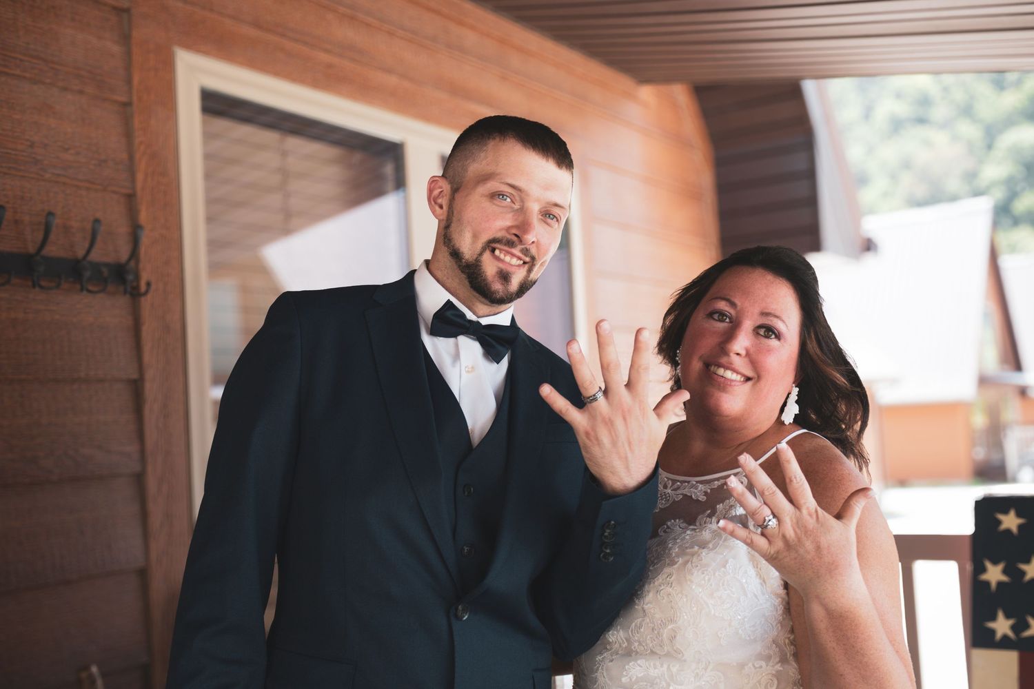 Candid wedding moments captured between a couple in a rustic wooden setting.