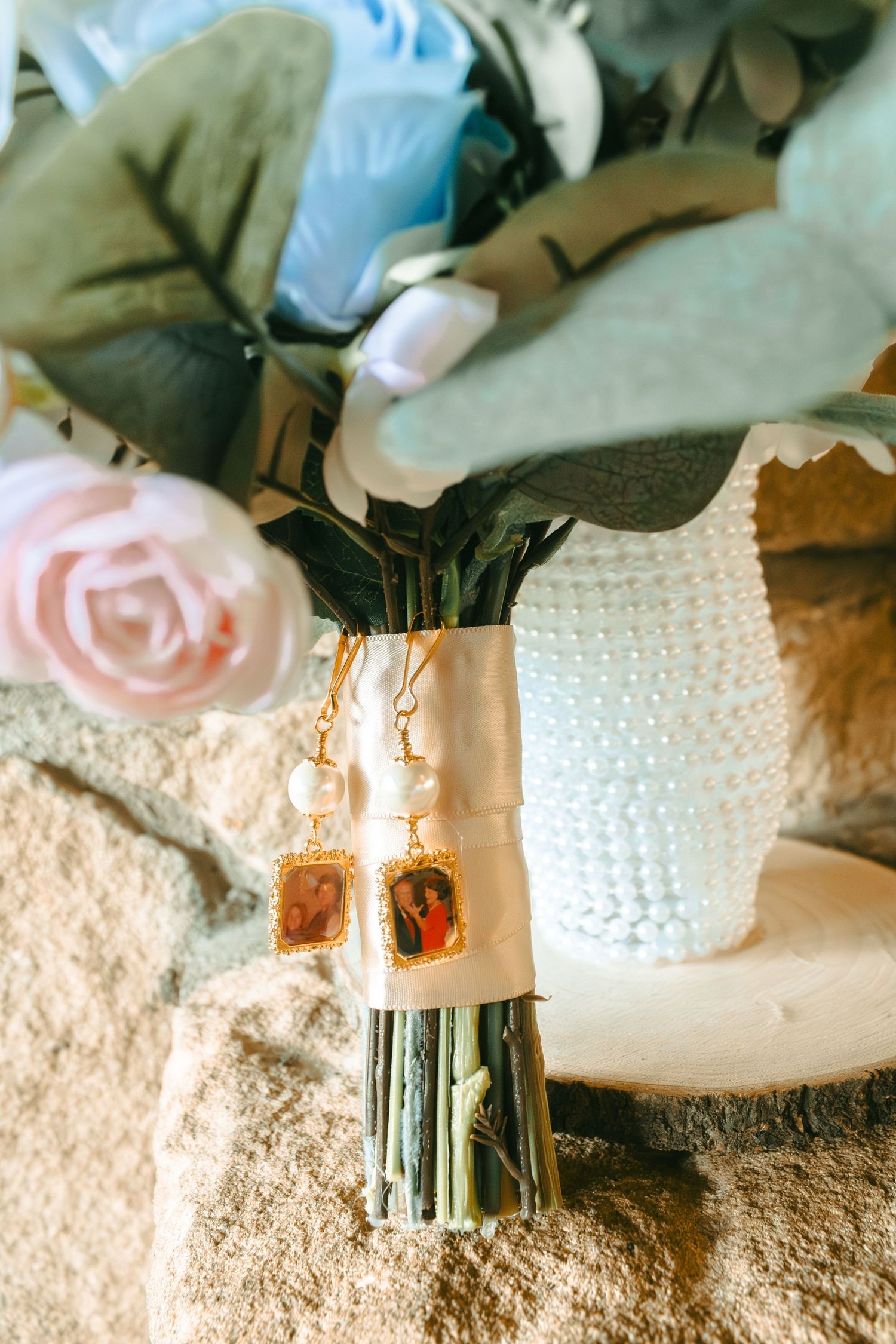 Close-up of wedding cake details with pearl decorations and floral accents.