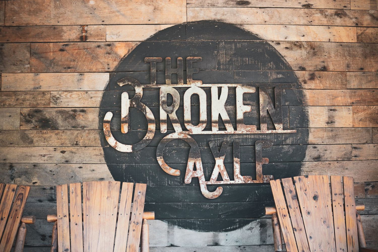 Rustic wooden wall with vintage signage and decorative elements.