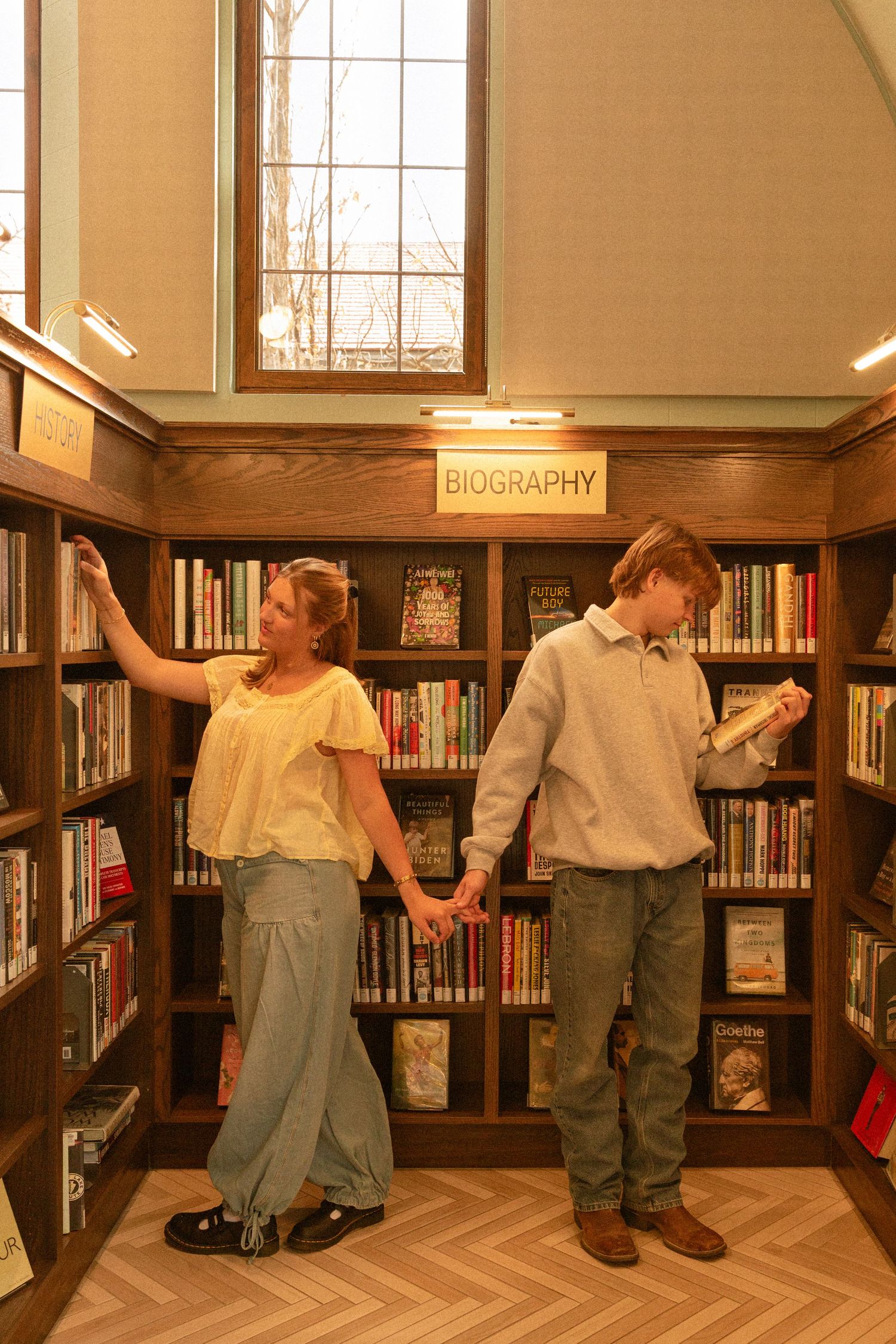 A sequence of photos shows a playful dance move in a library between bookshelves.