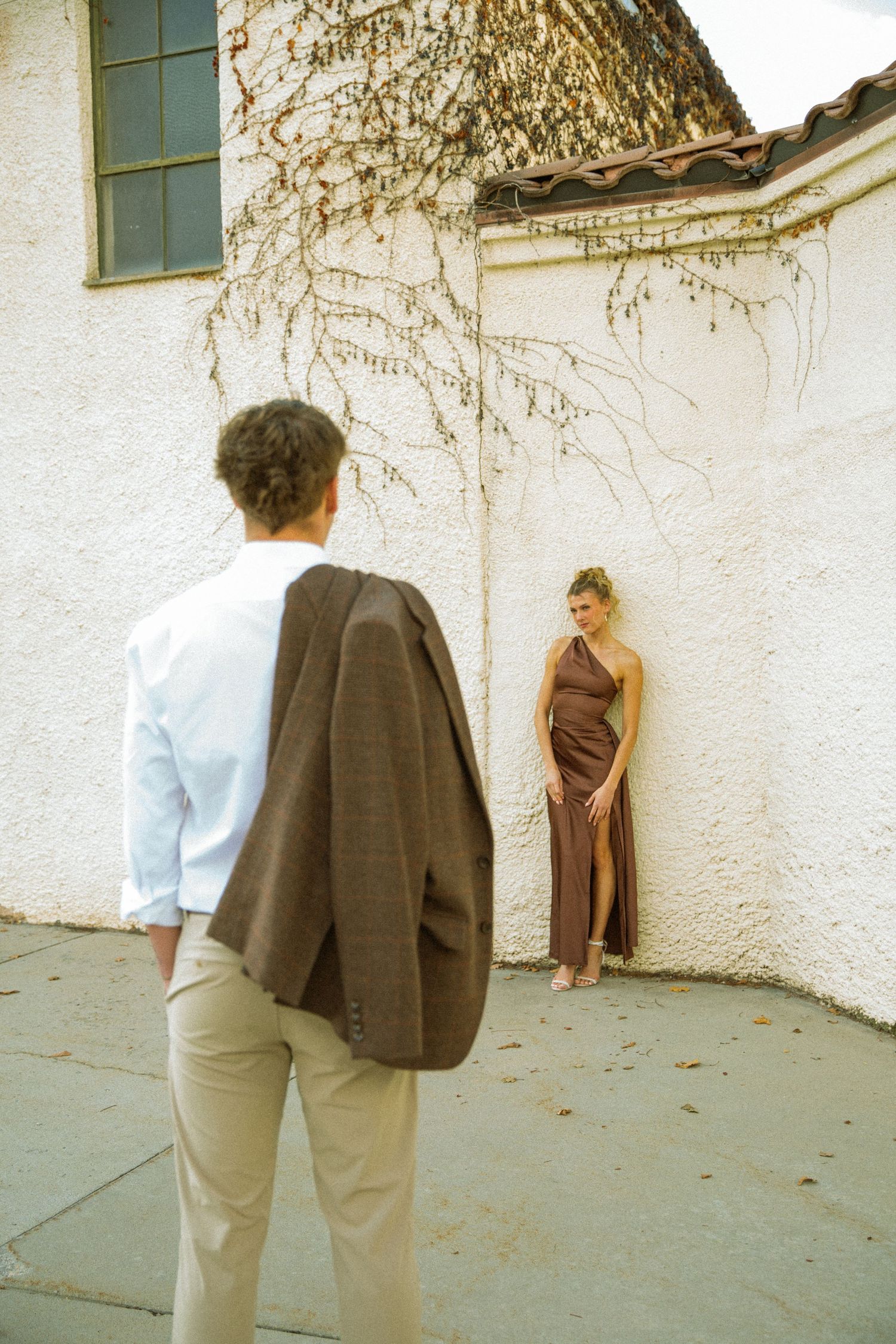 Three sequential images show people standing against a white wall with shadows cast from tree branches.