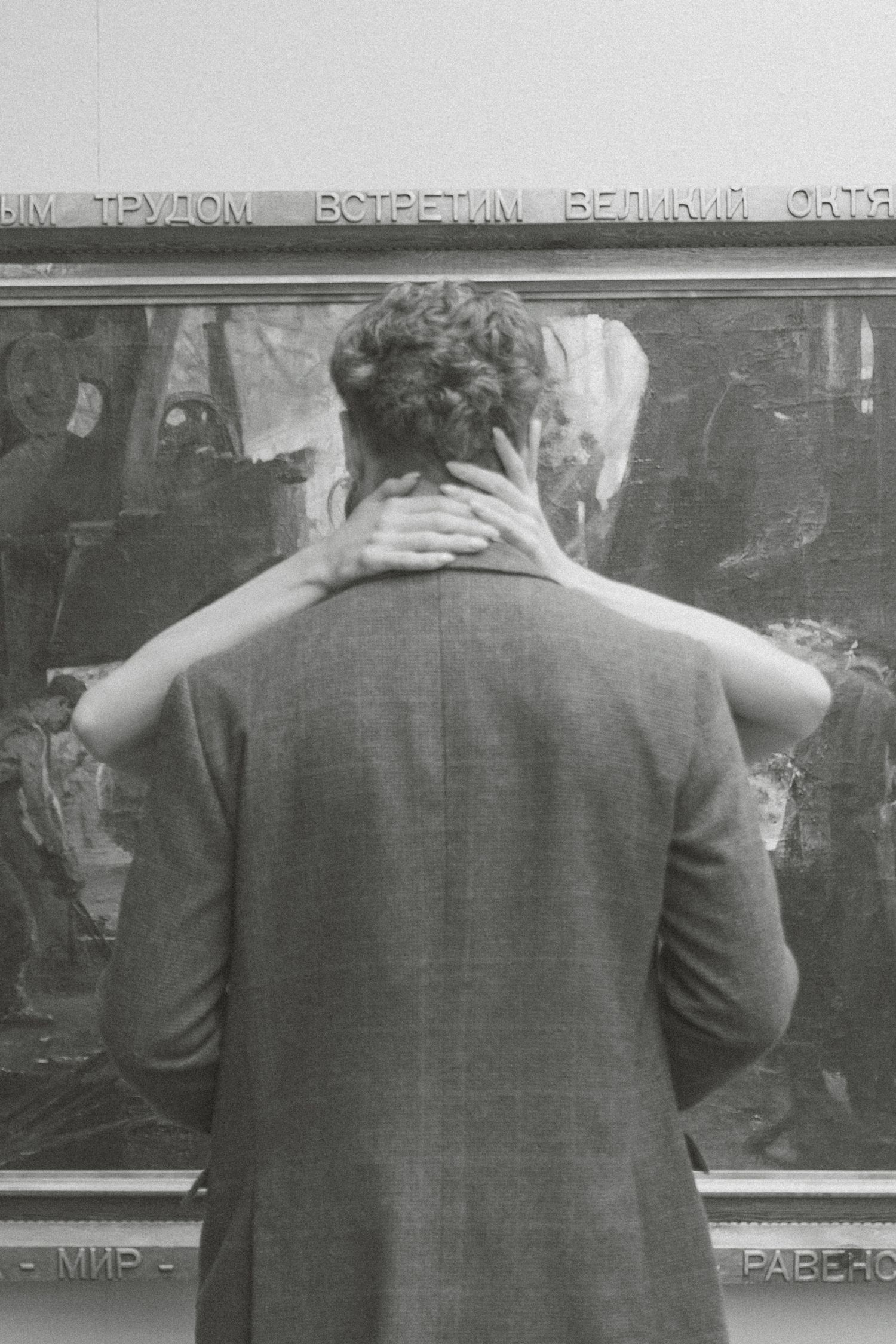 A sequence of black and white photos showing someone writing on a chalkboard from behind.