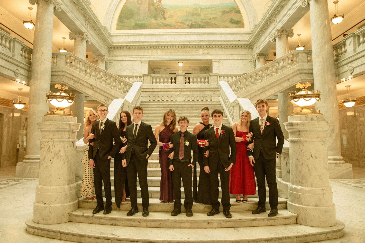 A panoramic view of people gathered in an ornate marble government building hallway with classical architecture and lighting.