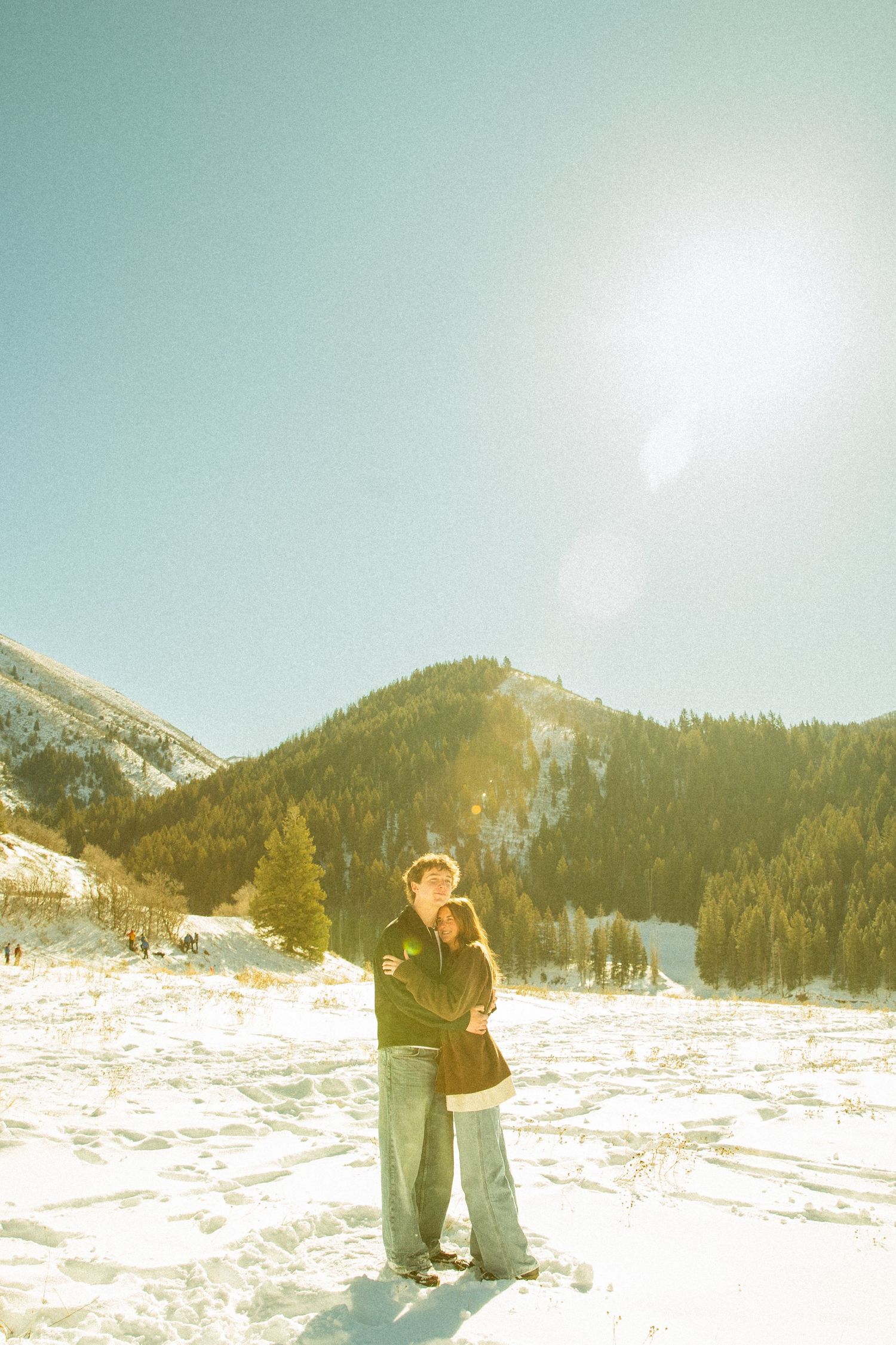 A panoramic sequence of people enjoying a snowy mountain landscape on a bright sunny winter day.