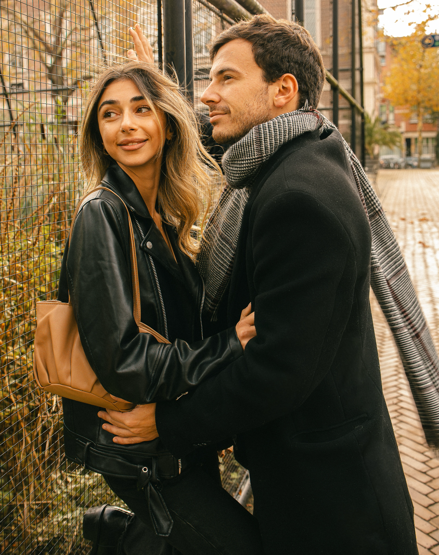 Man standing near his wife with natural light in a zoo.