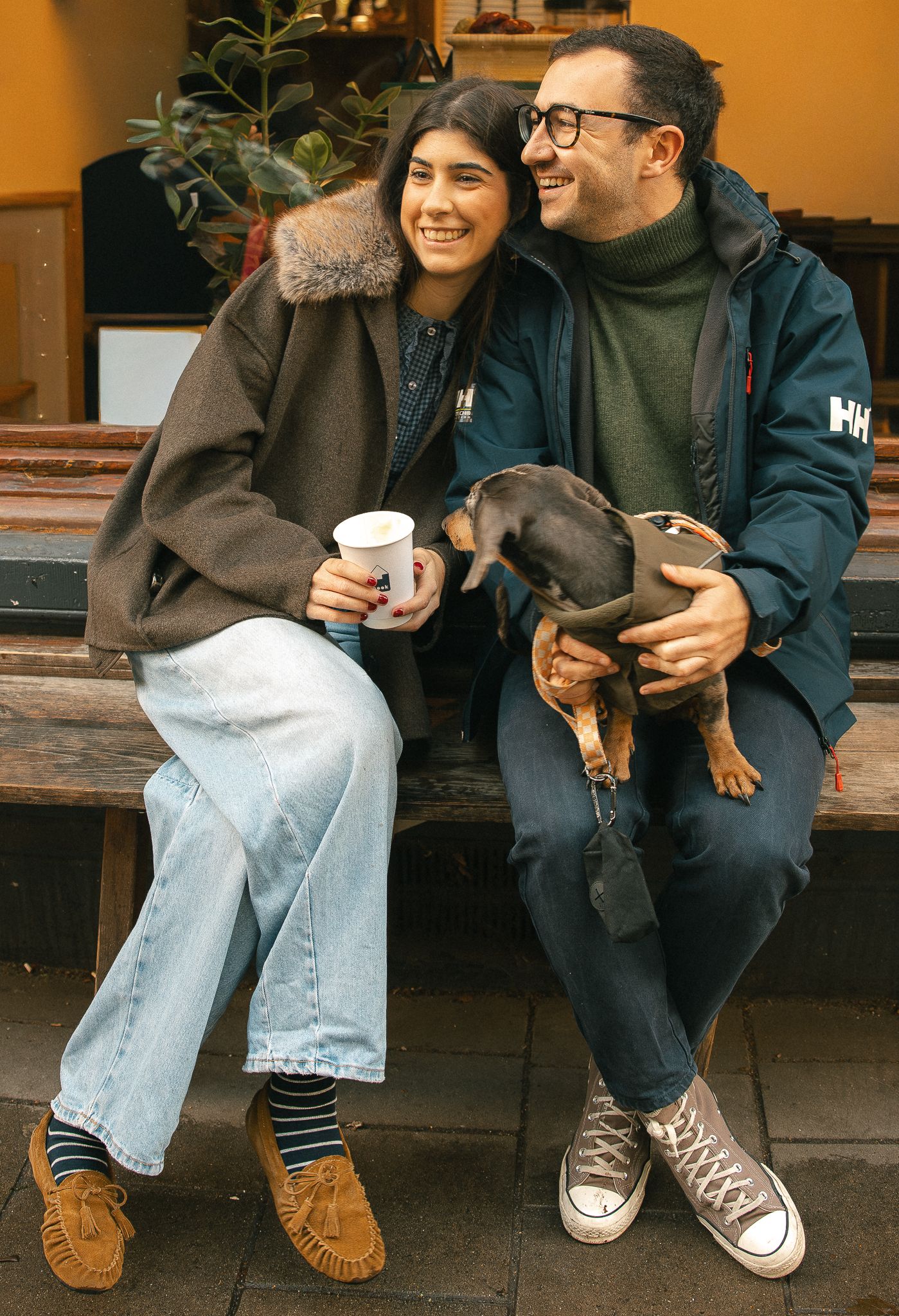 A lovely family portrait with closeness, laughter, coffee and a cute dog.
