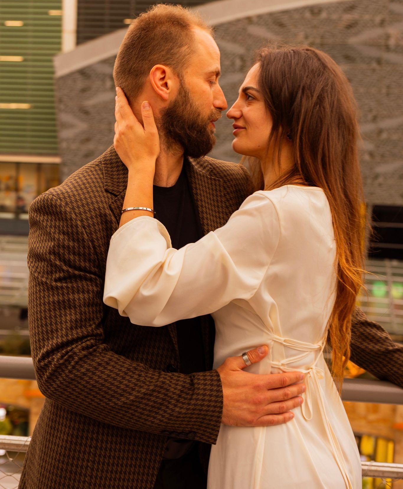 Couple embracing in soft afternoon light.