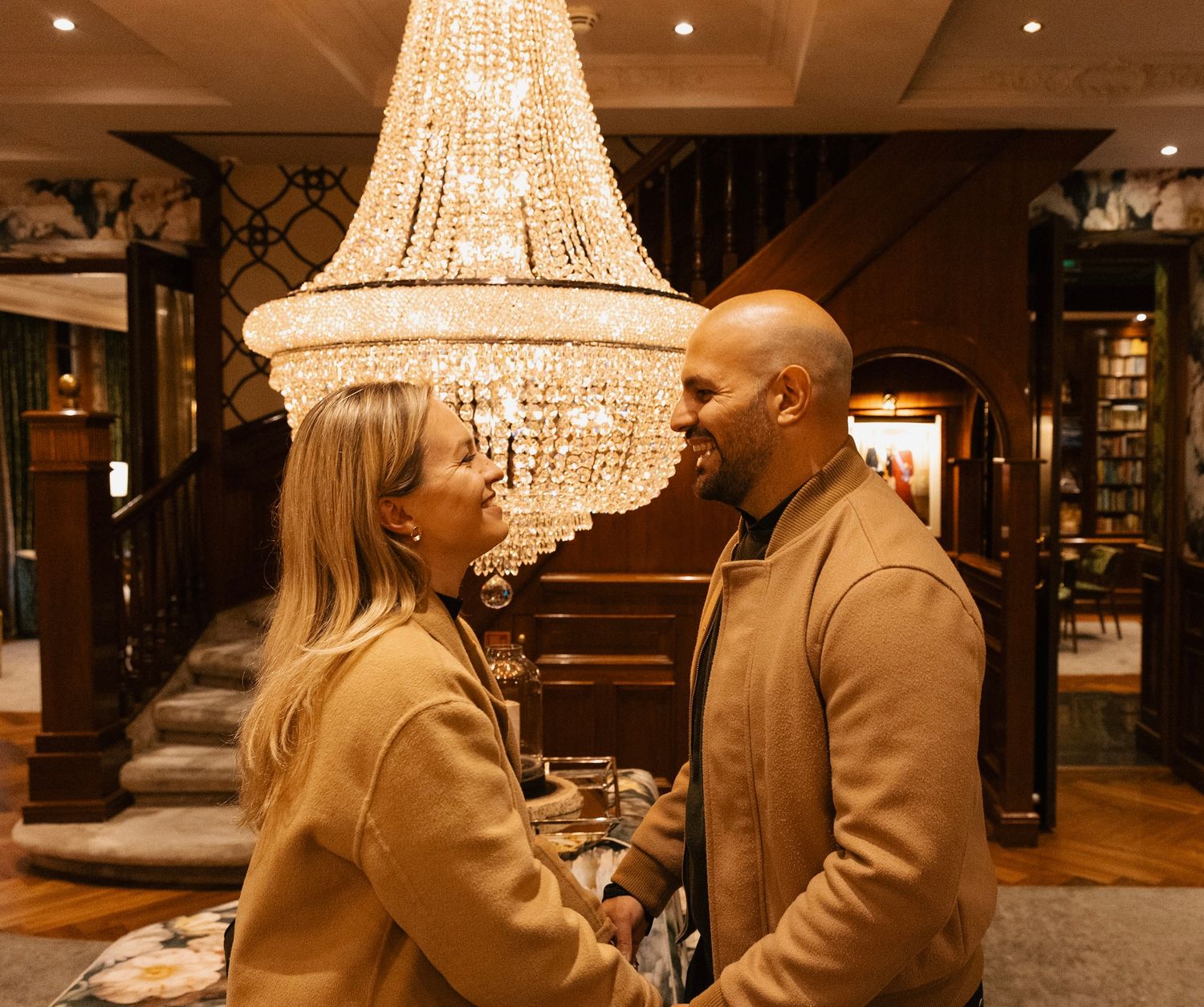 Couple embracing in a hotel lobby.