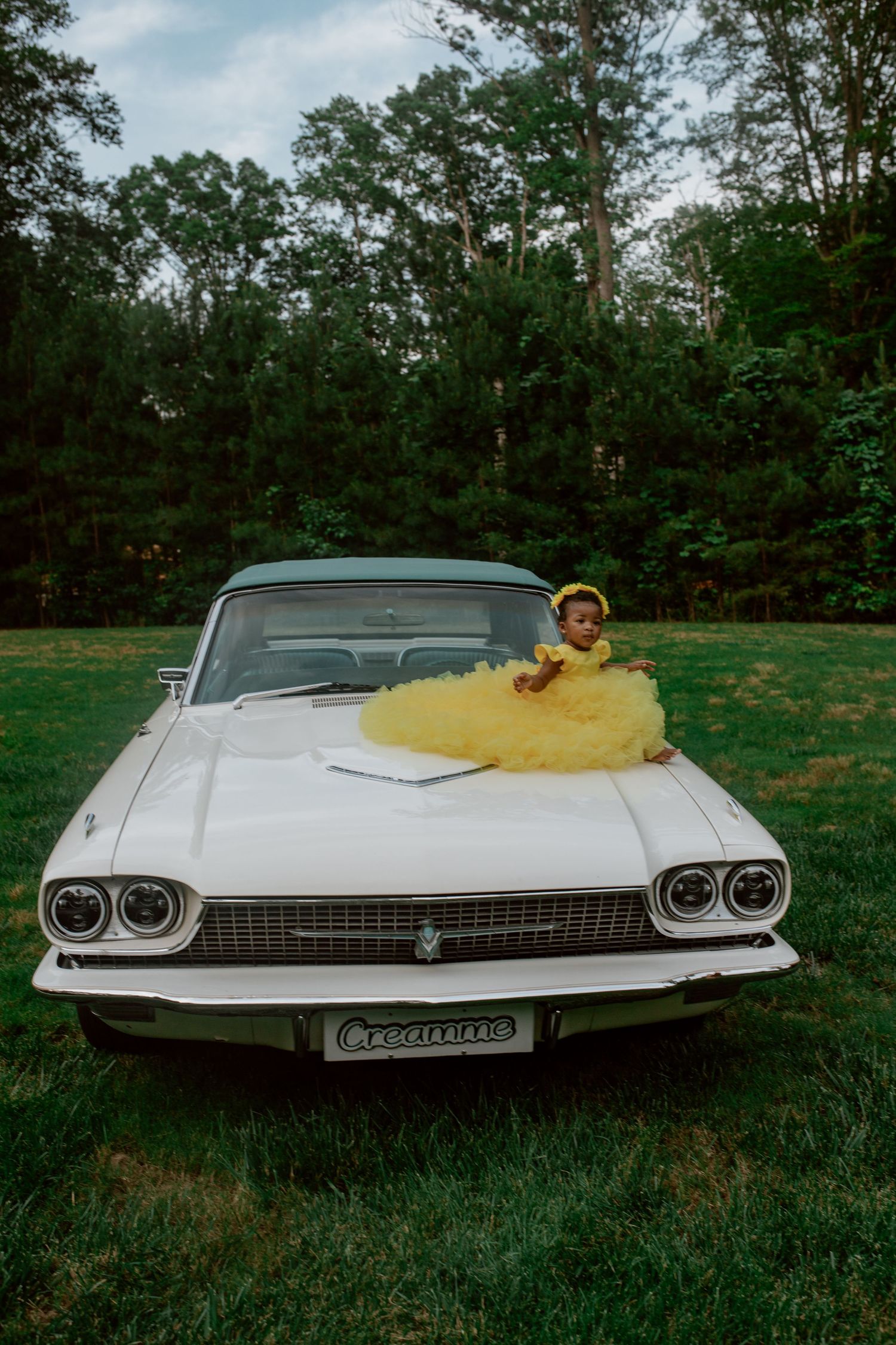 Vintage white Cadillac photographed from multiple angles in a grassy outdoor setting.