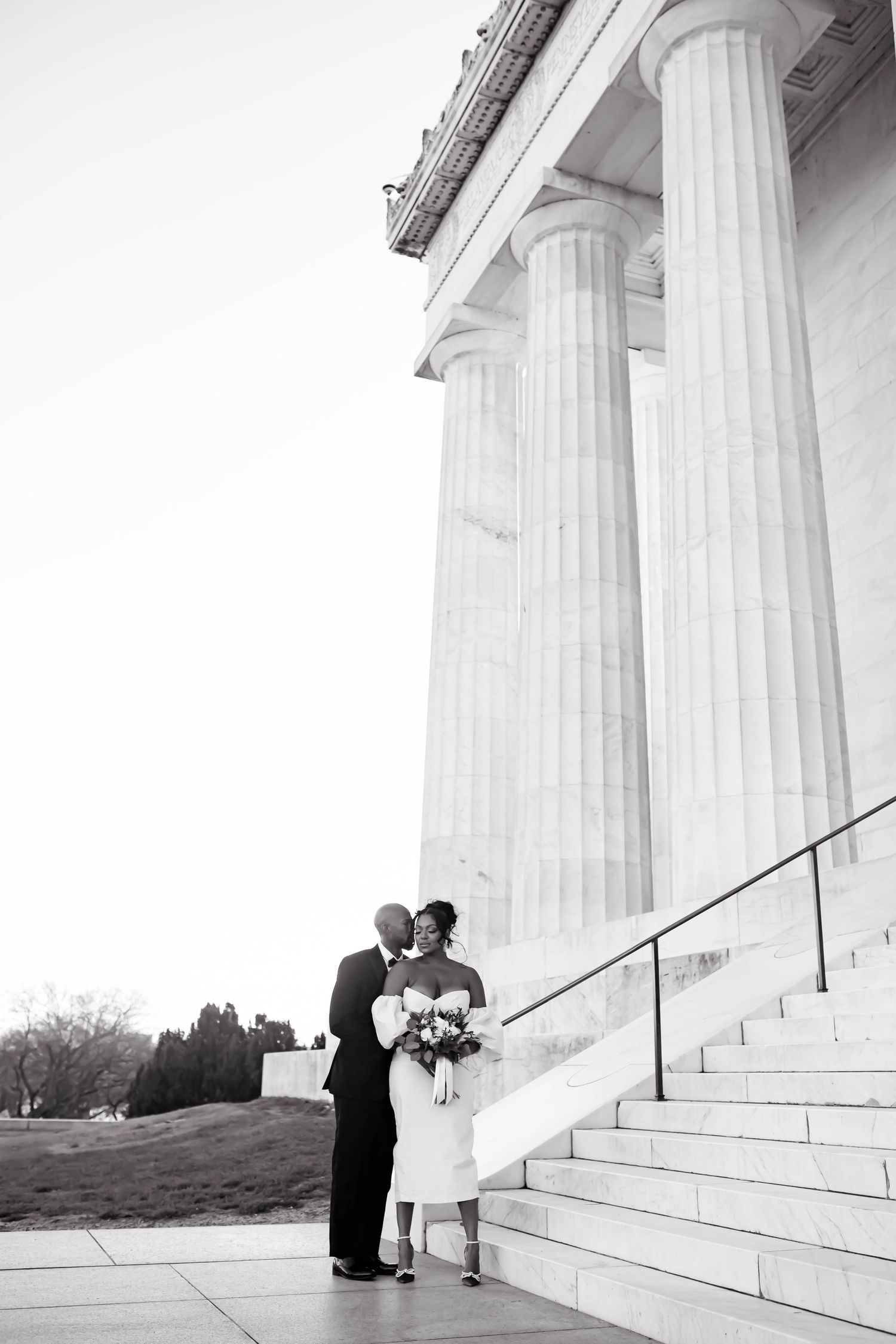 Wedding ceremony silhouettes against majestic white Greek columns.