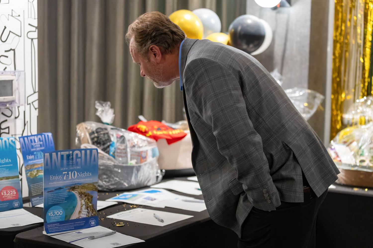Donor looking at raffle items during 1st annual Town and Country Gala