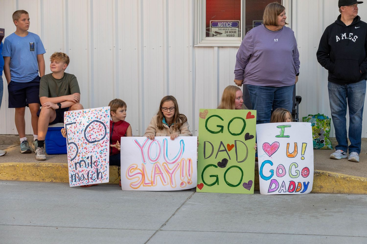 children rooting on dad during the 50 mile march