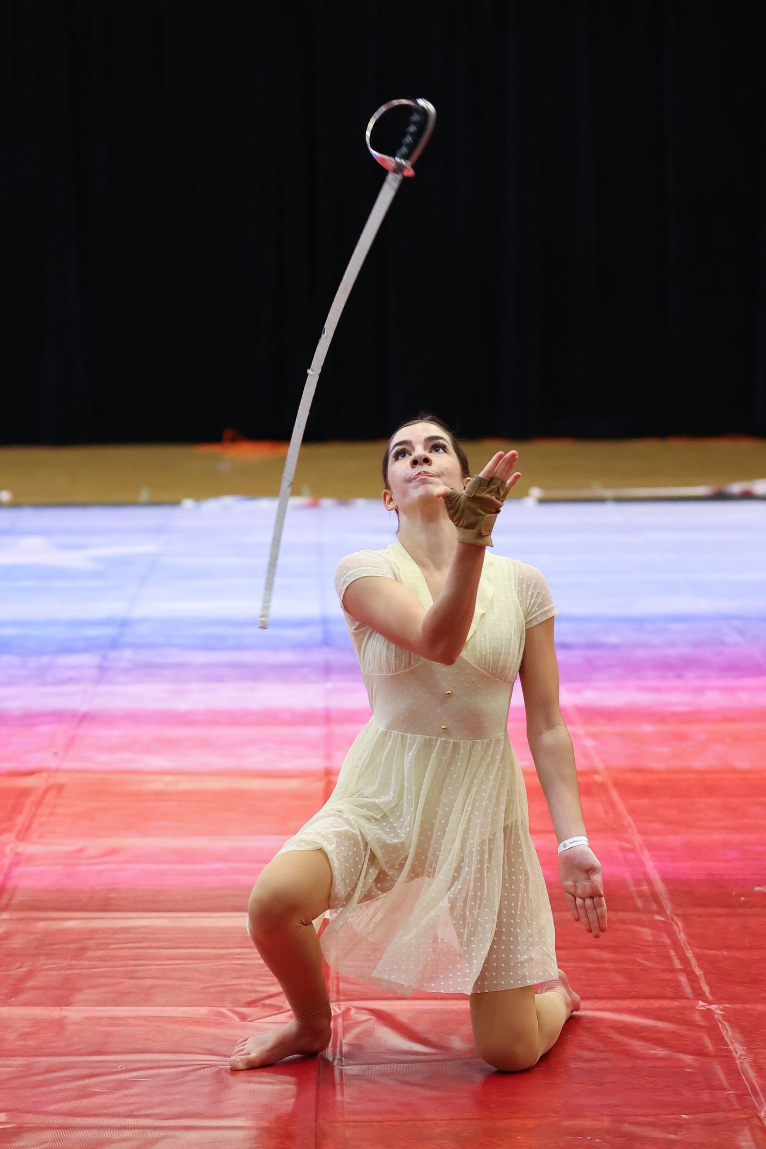 color guard performer catching saber during WGI Omaha