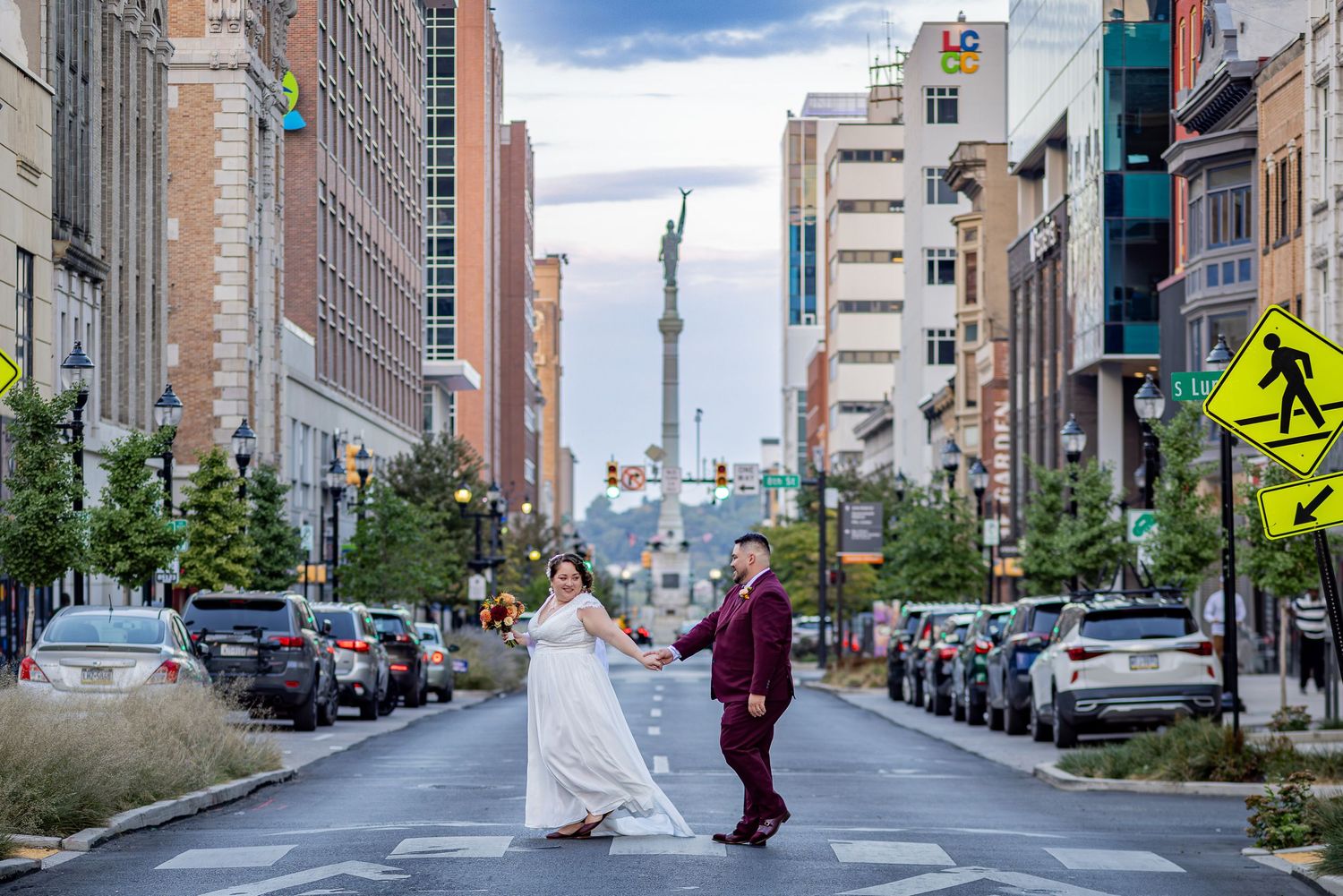 Urban wedding photoshoot on an empty city street with tall buildings and CN Tower in background.
