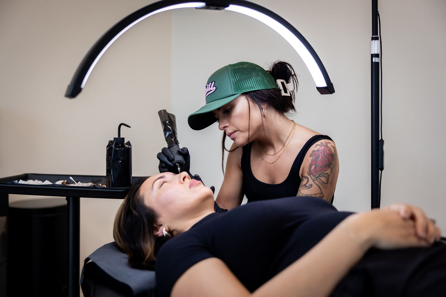 Professional photography studio setup with ring light and equipment.